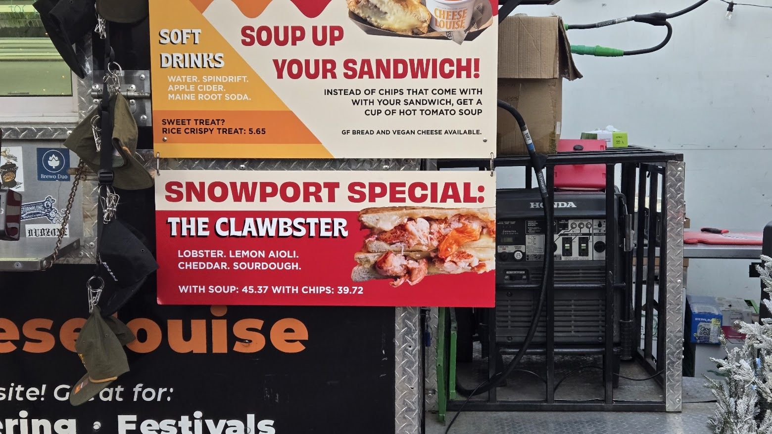 Food truck menu showing a special called "The Clawbster" featuring lobster, lemon aioli, cheddar, and sourdough, with options for soup or chips. Also offers soft drinks and a rice crispy treat.