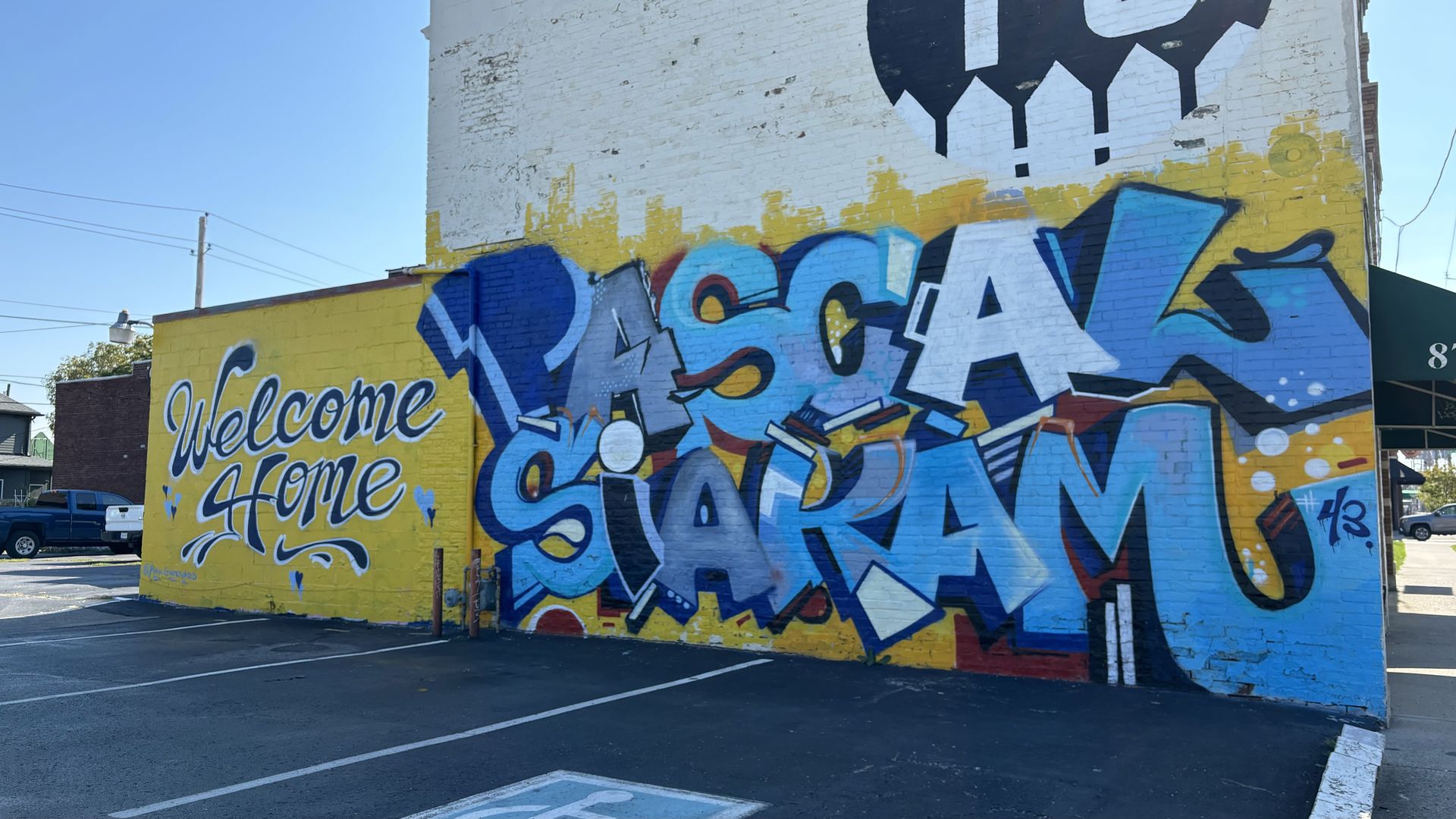 A mural that says "welcome home Pascal Siakam" in blue and yellow