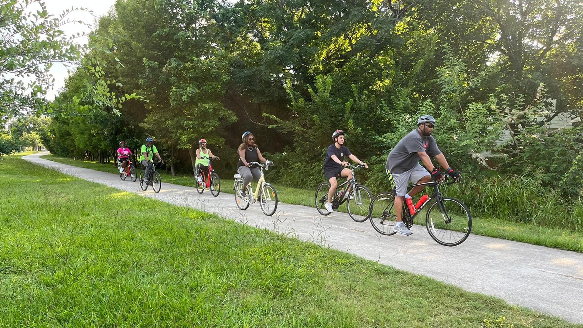 A group of cyclists pedals along the Columbia Tap Trail in Houston