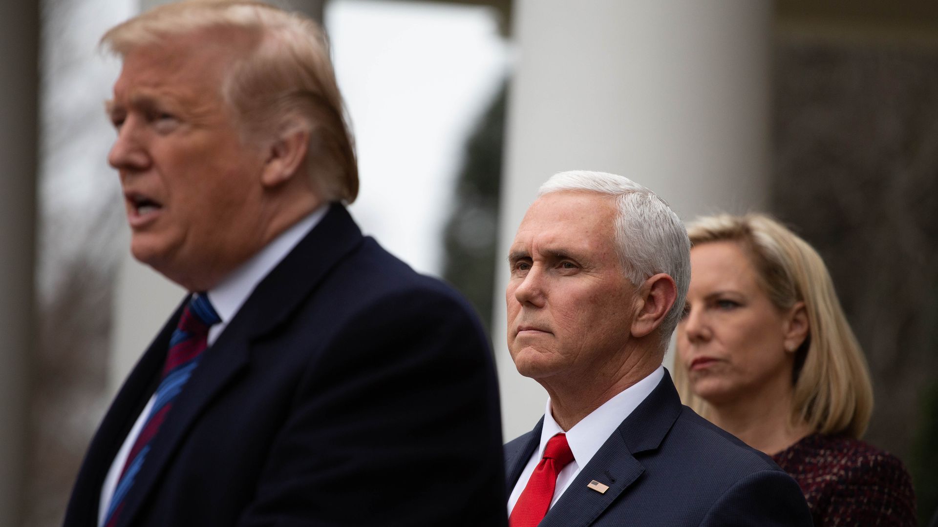 Vice President Mike Pence stands behind President Trump.