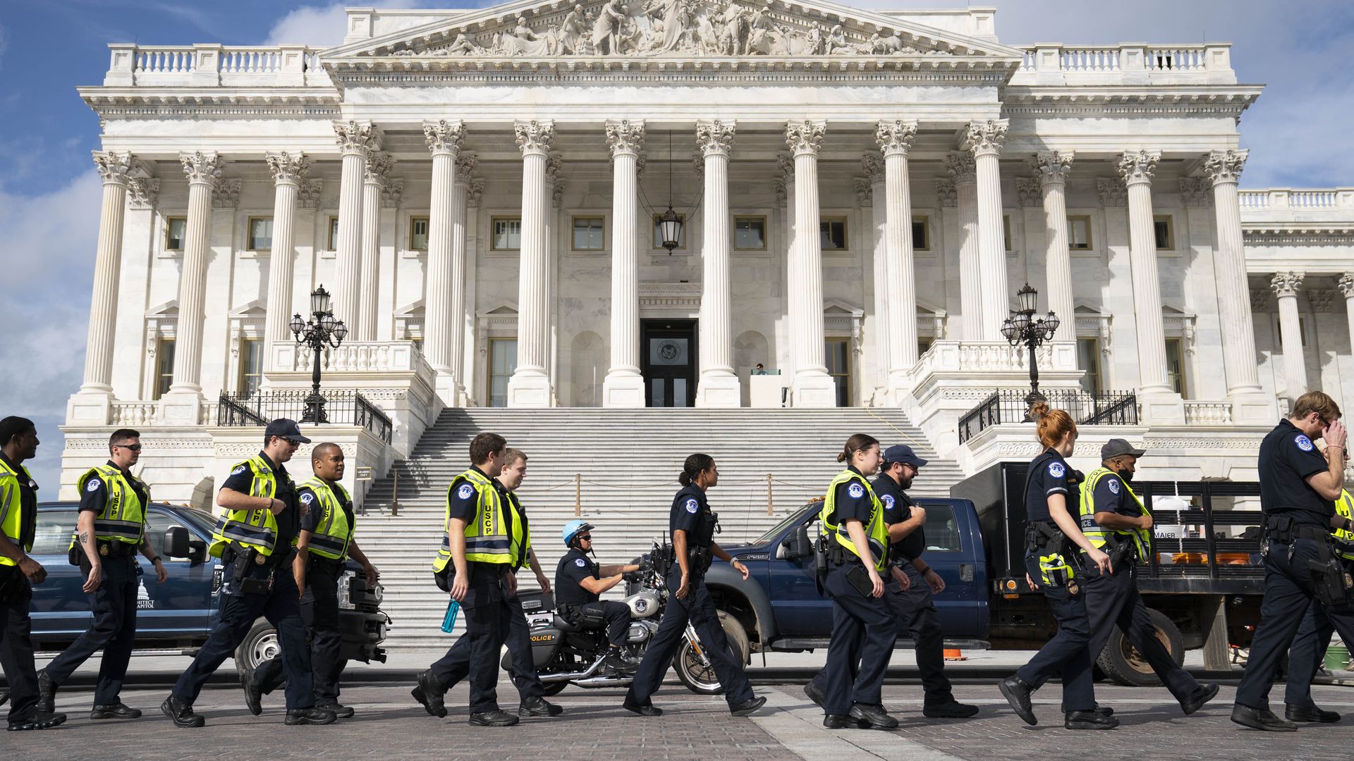 U.S. Capitol Police officers walk past the U.S. Capitol in Washington, D.C., U.S., on Tuesday, Sept. 21, 2021. House Democrats set up a Tuesday 