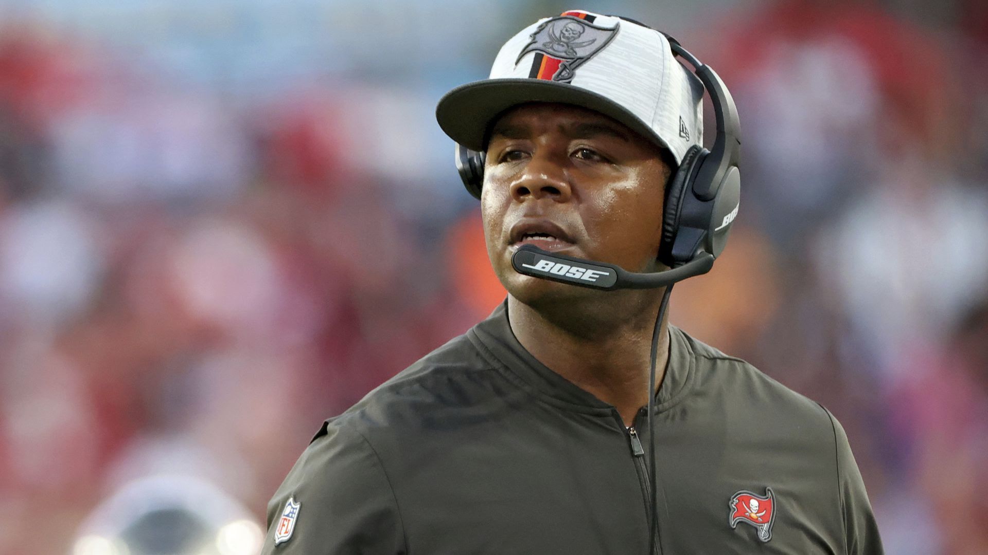 Byron Leftwich wears a headset during a game.