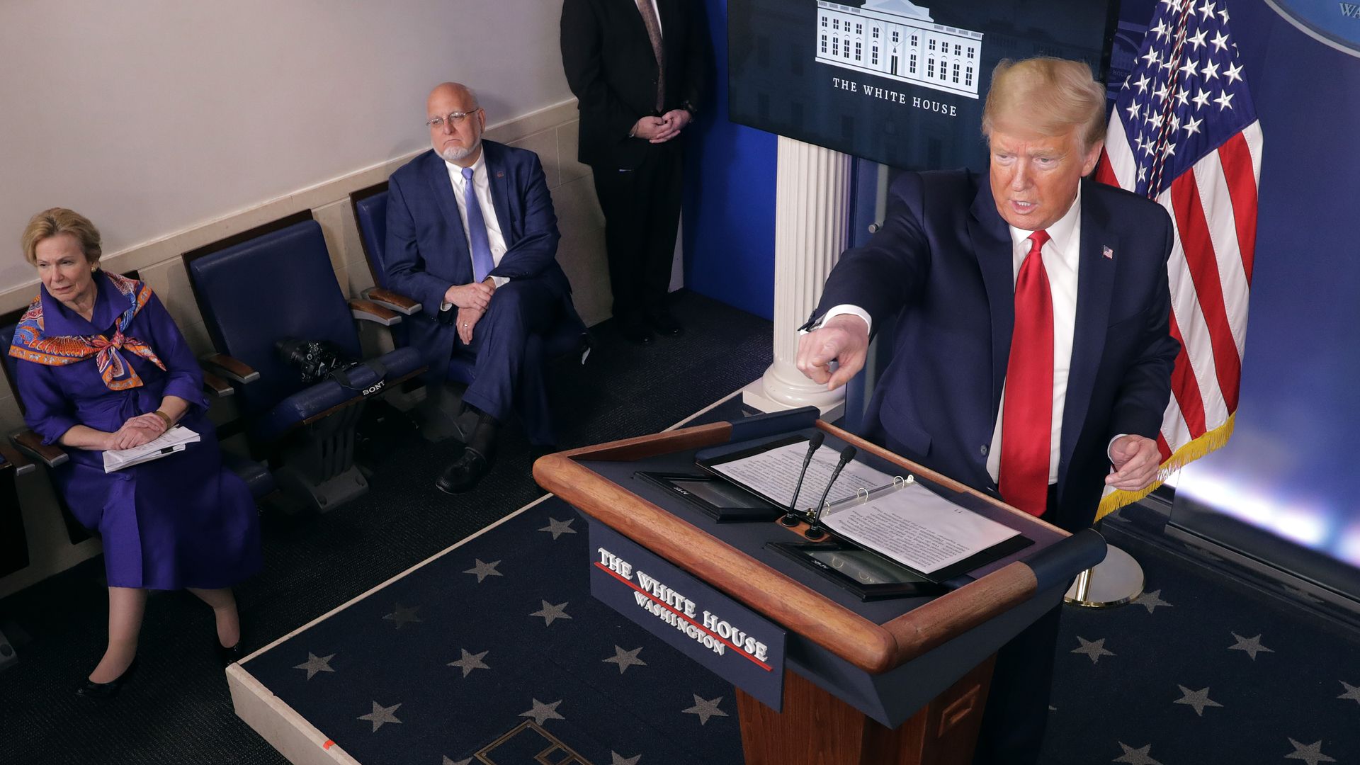 President Donald Trump calls on reporters during a news conference with White House coronavirus coordinator Deborah Birx (L) and Centers for Disease Control and Prevention Director Robert Redfield 