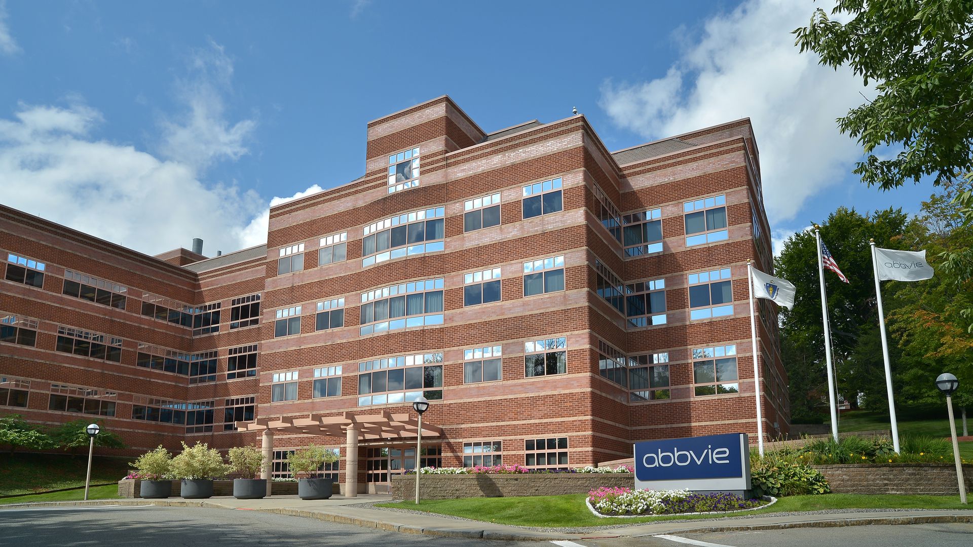 Multi-story AbbVie building with flags outside