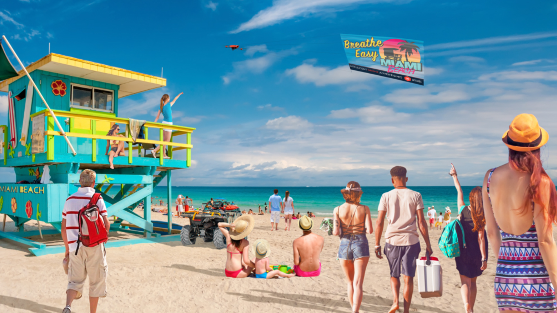 People at the beach, looking at a flying billboard.