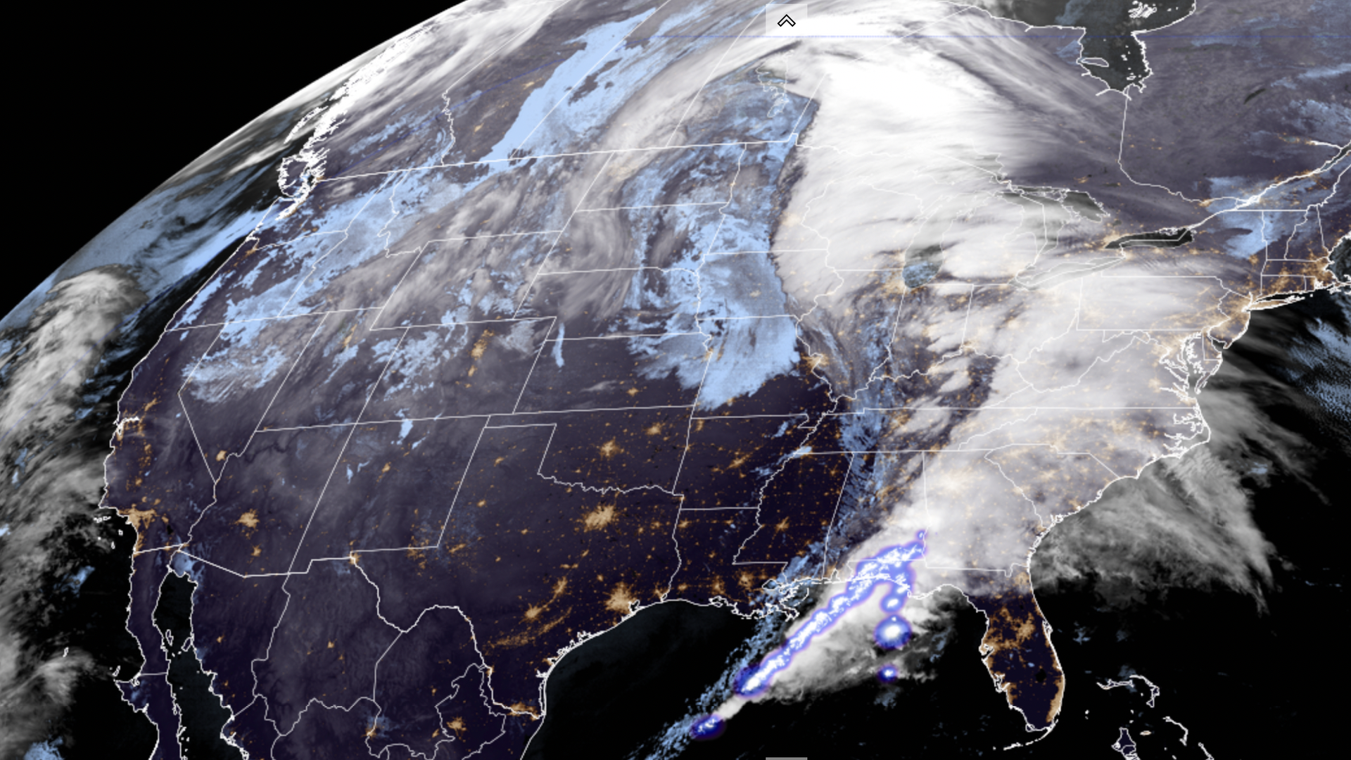 A satellite image showing the sprawling storm that's sweeping the US, with thunderstorms and lightning in the South and blizzard conditions across the Plains, Midwest and Great Lakes.