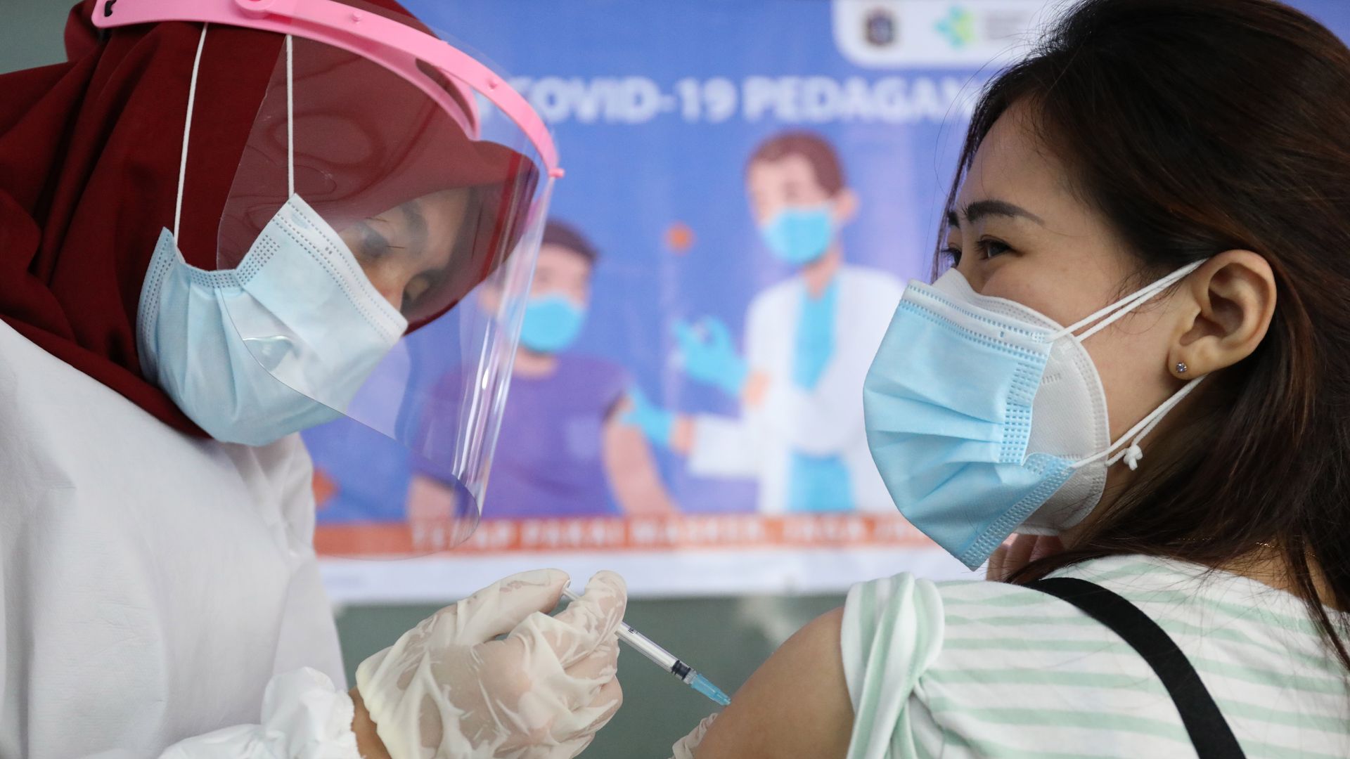 Officers injected the Covid-19 vaccine at traders at Tanah Abang Market, Central Jakarta City.