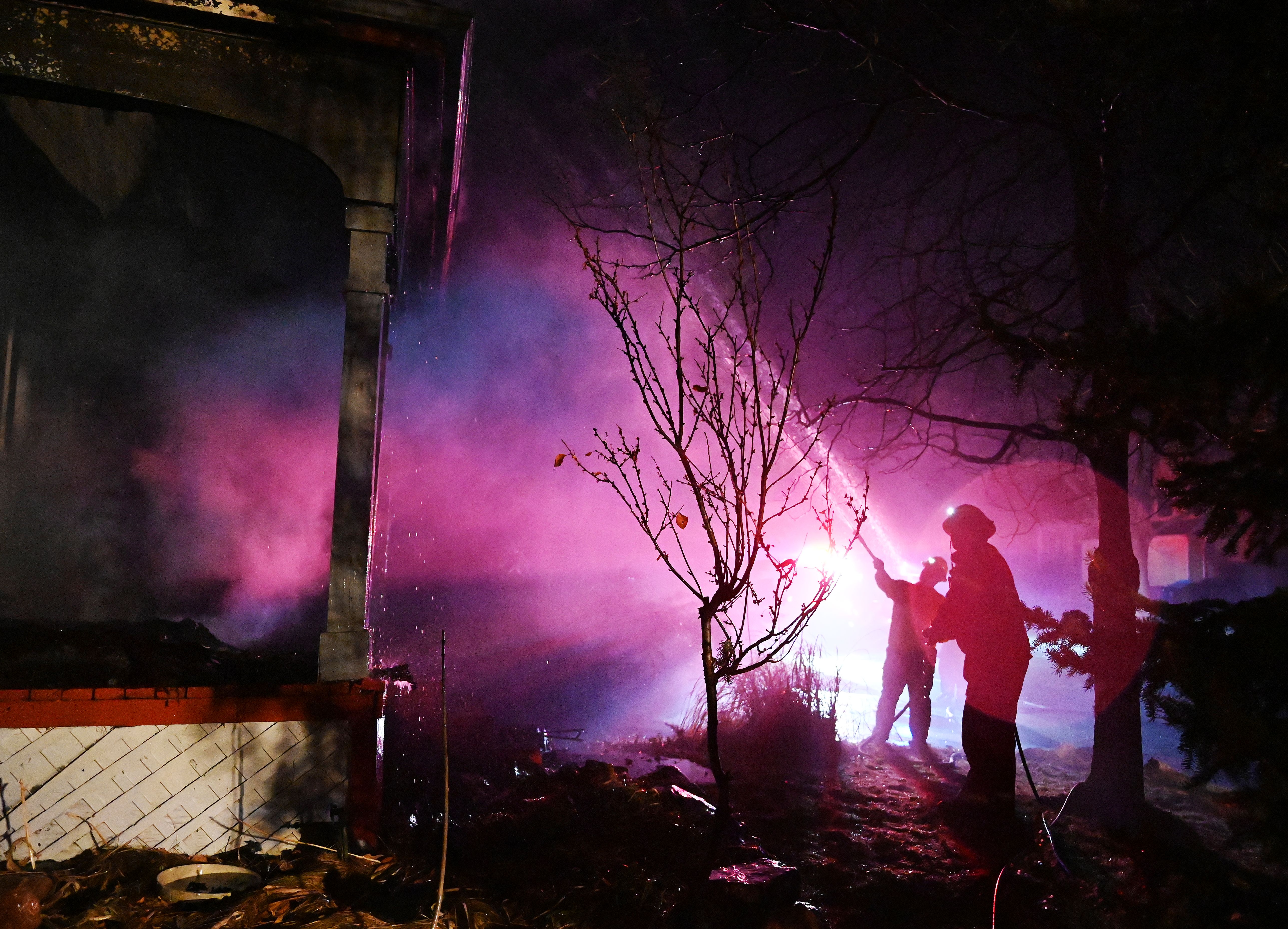 LOUISVILLE, COLORADO - DECEMBER 31: Fire crew work to put out flames at a home burnt in the Marshall Fire in Boulder County on December 31, 2021 in Louisville, Colorado.