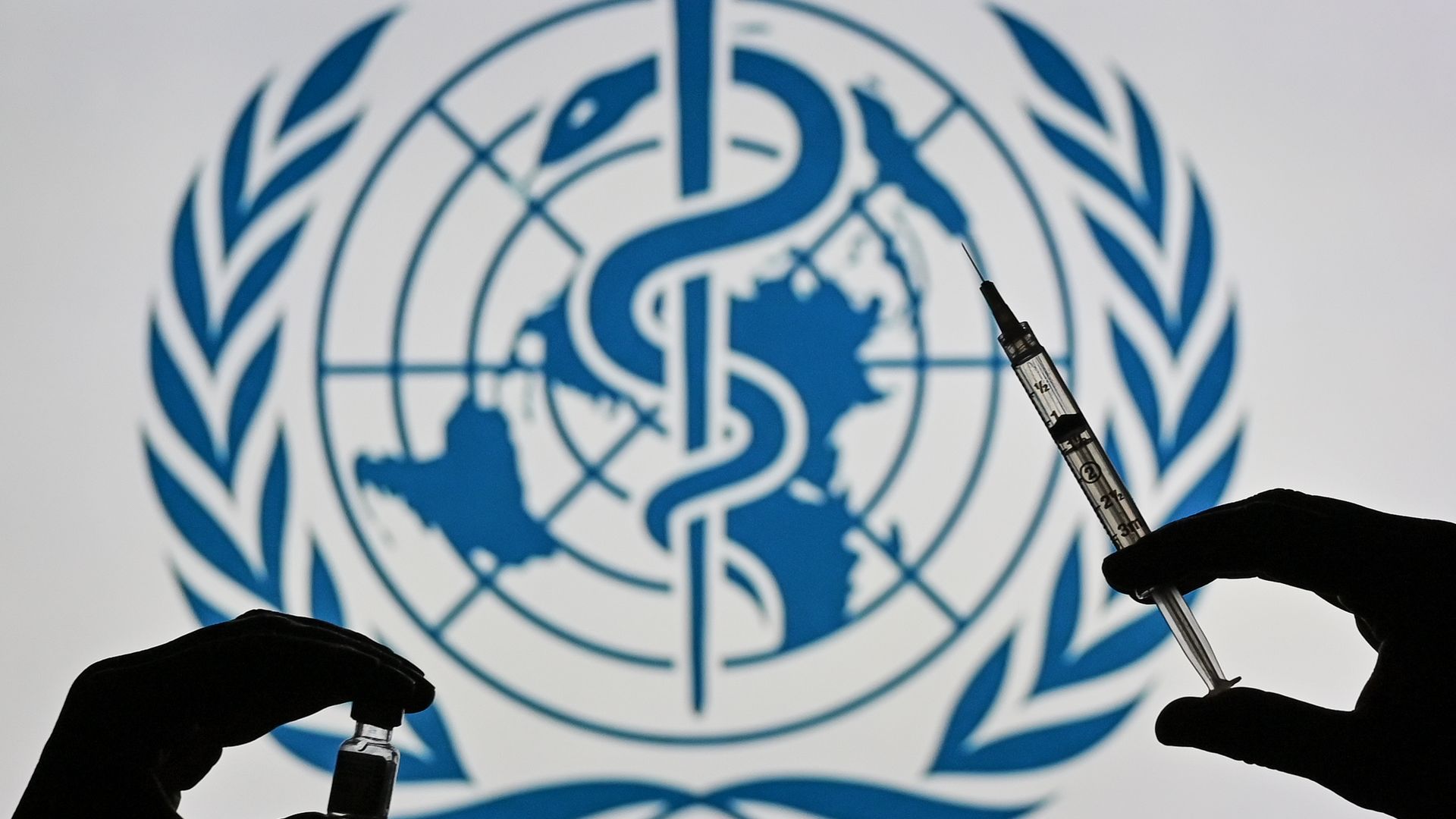 WHO logo with a person holding a medical syringe and a vaccine vial.
