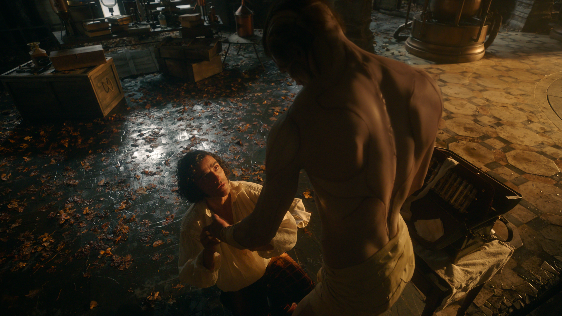 A man looks up at a tall monster