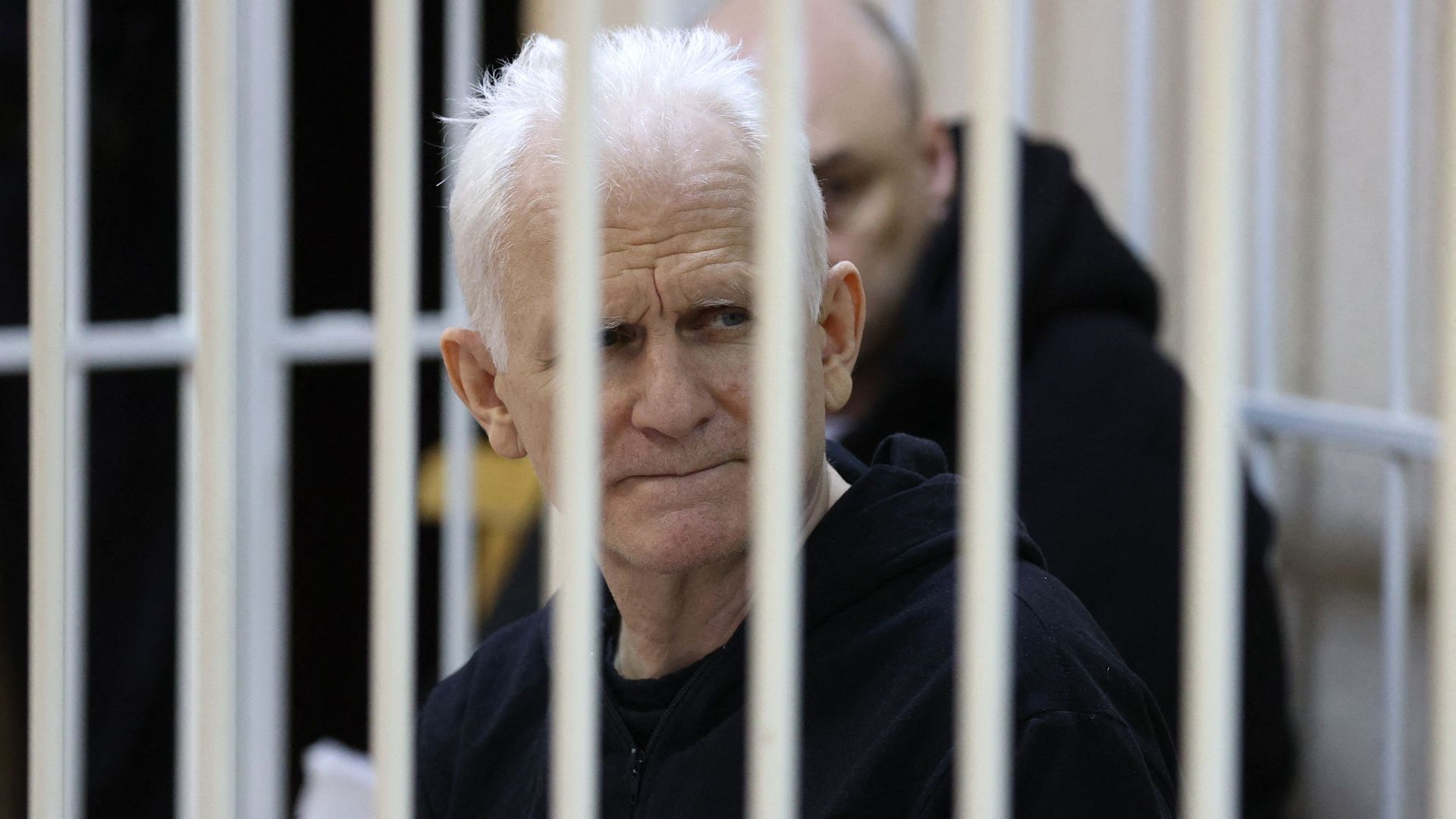 Nobel Prize winner Ales Bialiatski inside a defendant's cage in a courtroom in Minsk, Belarus, in January 2023.