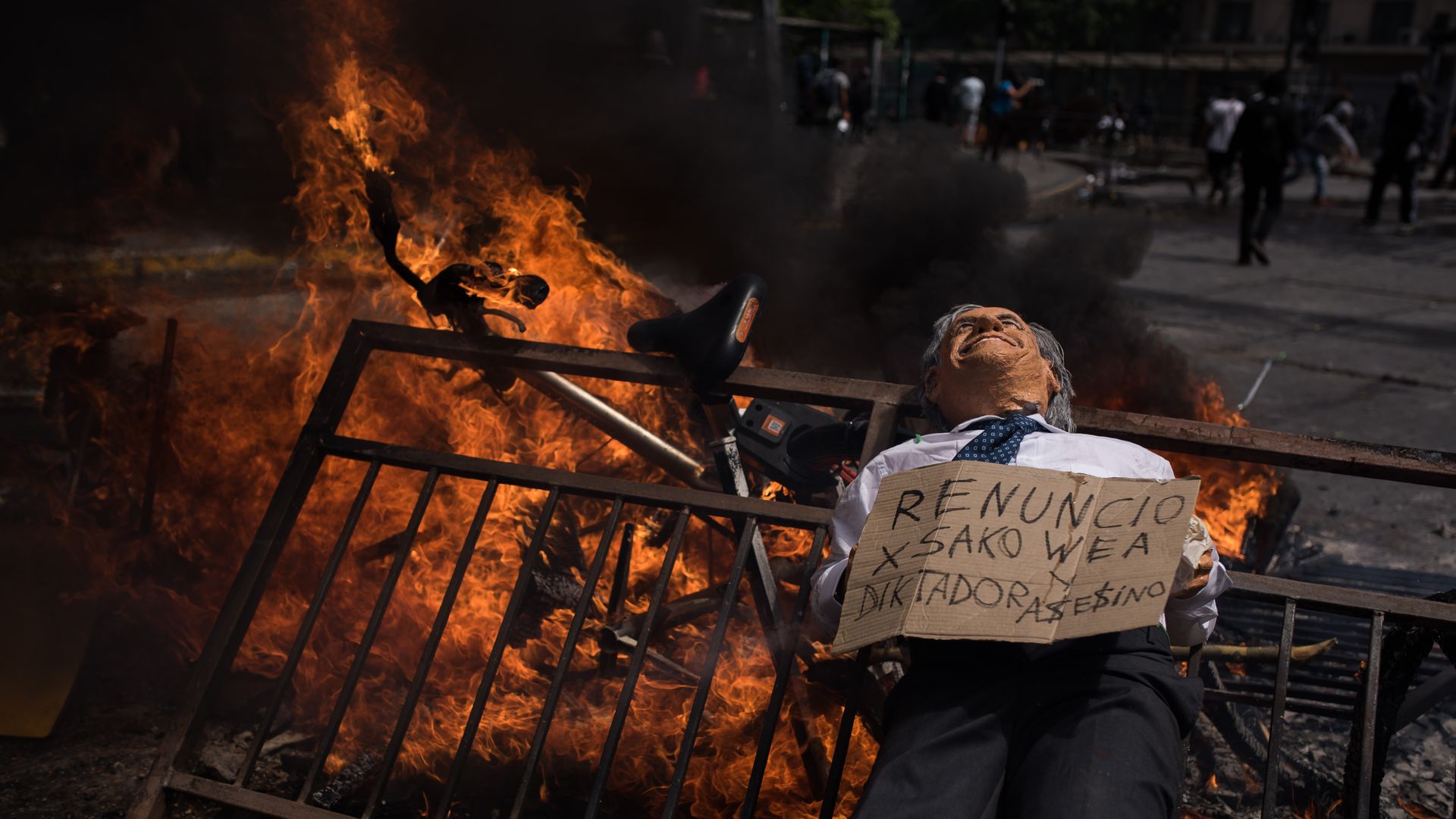 Protesters burn barricades as they gather to march on the sixth day of social riots for increases in public transport in Santiago of Chile.