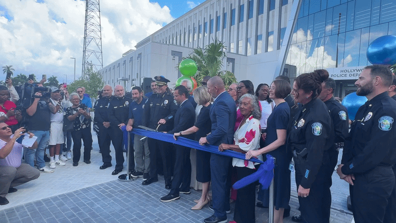 Hollywood Mayor Josh Levy cuts the blue ribbon next to police officers and commissioners in front of the new Hollywood Police headquarters. 