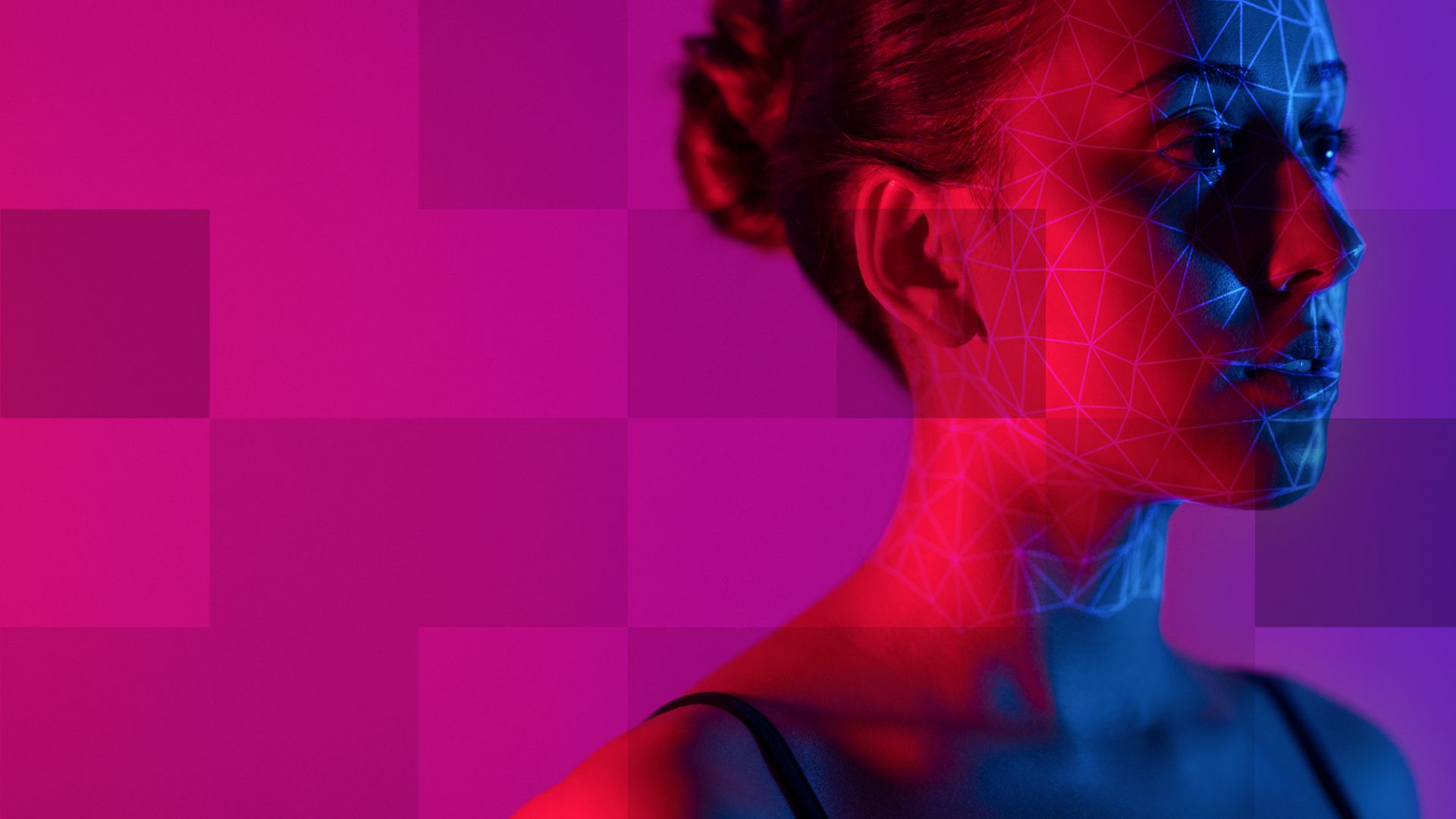 A woman getting her face scanned. She is standing in front of a purple-pink background. 