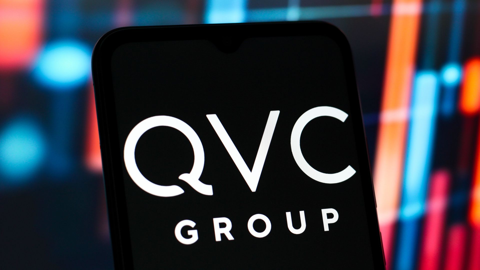 In this photo illustration, the QVC Group logo is seen displayed on a smartphone screen. 
