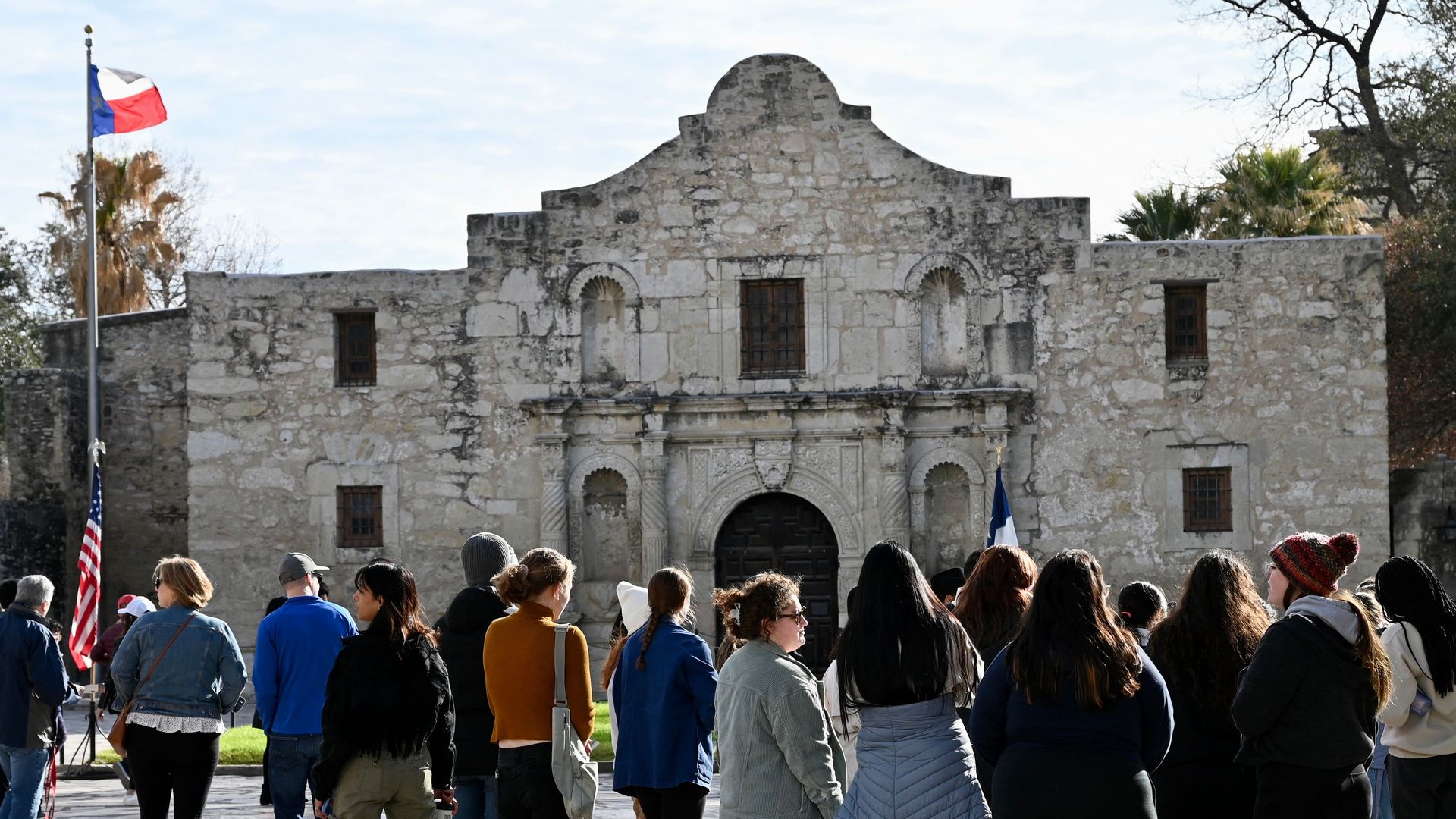 Visitors gather in front of the Alamo.