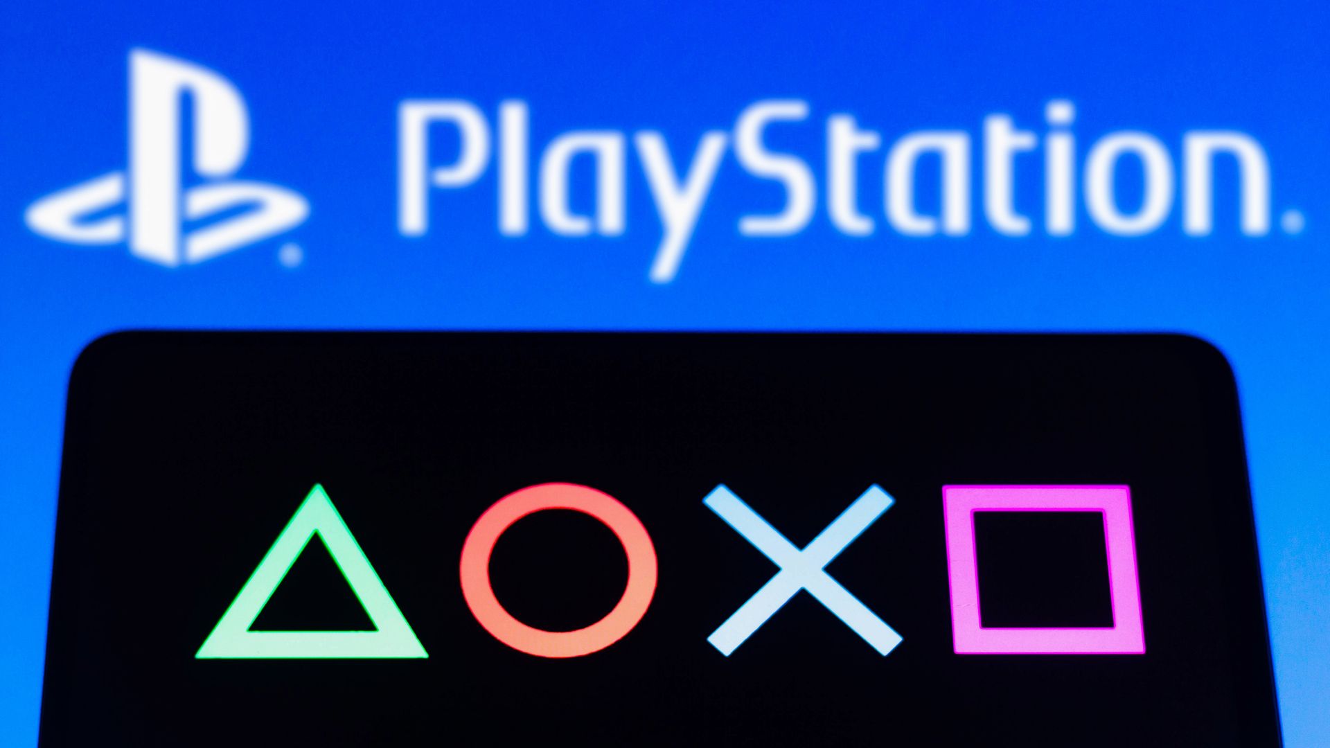Photo of a PlayStation logo and symbols representing PlayStation controller buttons