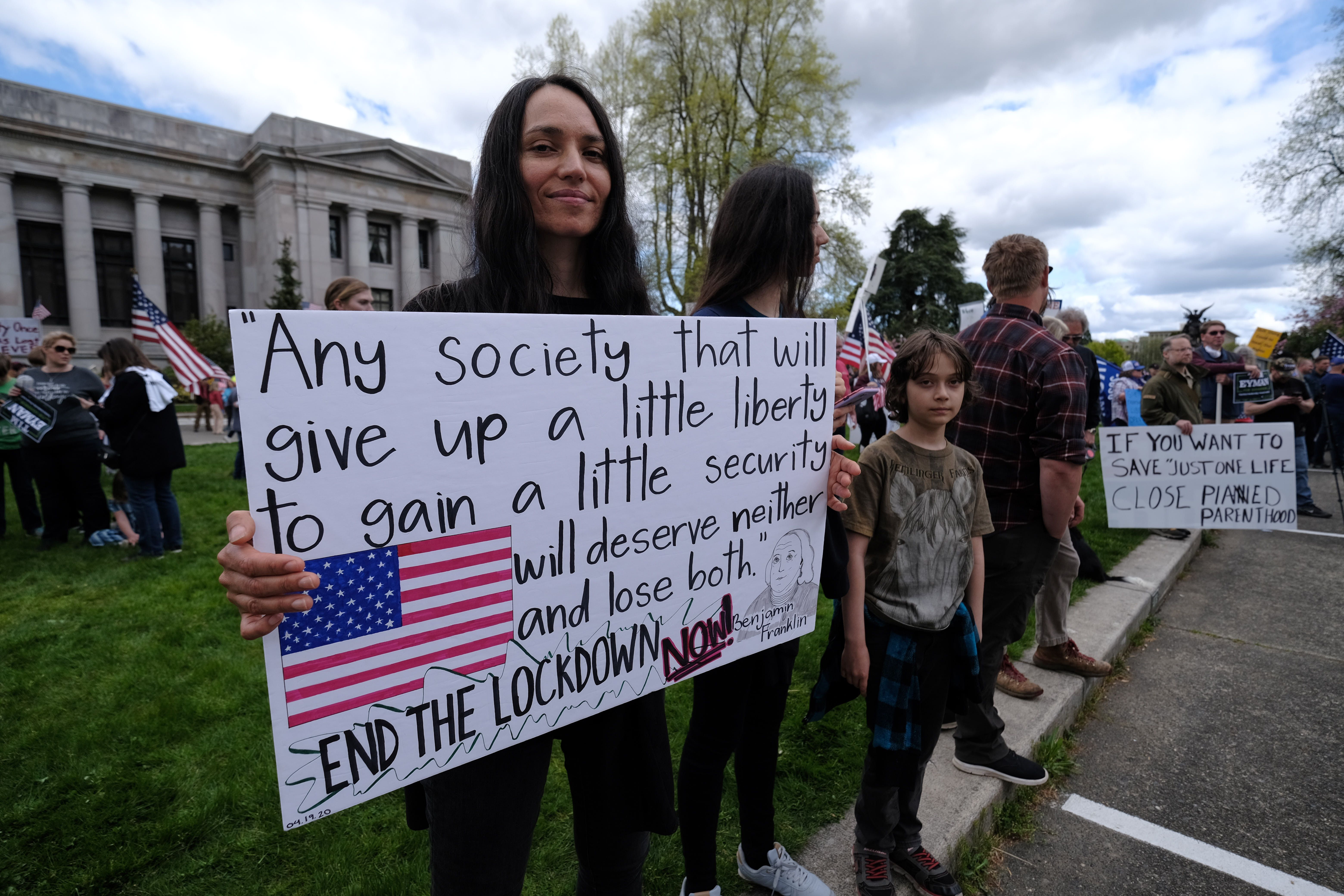 Hundreds of protesters demonstrate outside the state Capitol to speak out against against Governor Inslee's stay home order to battle the novel coronavirus