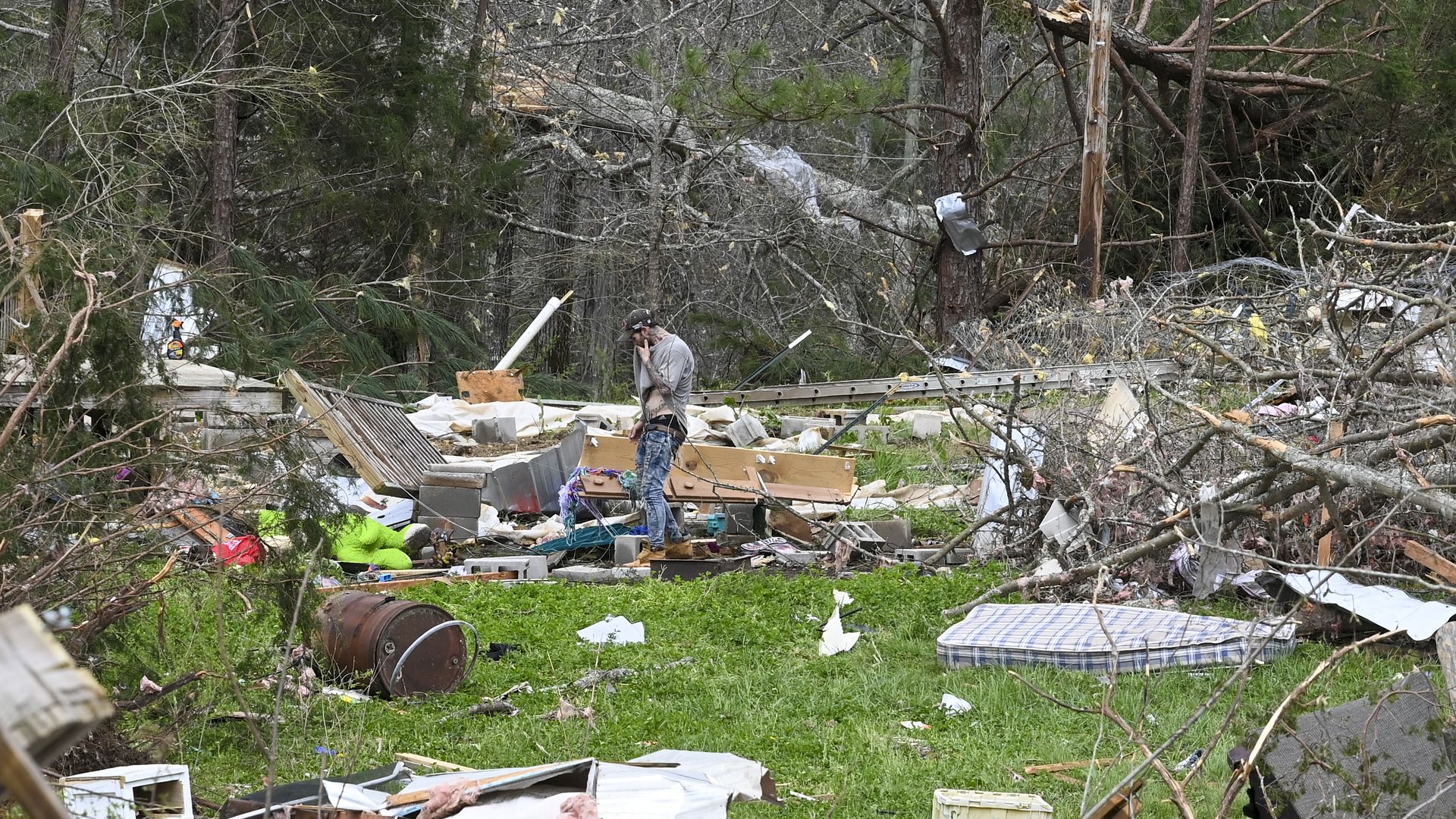 Photo of a person examining damage to a home