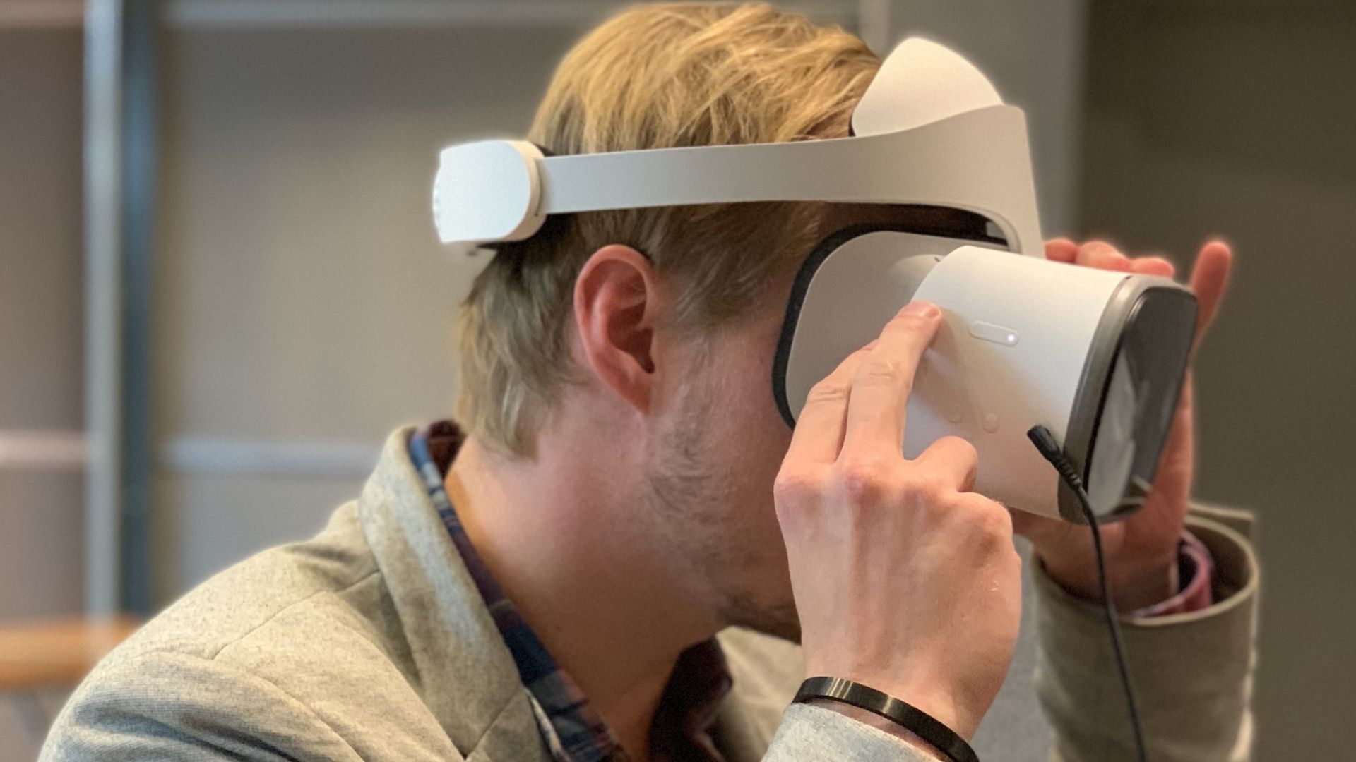 A seated man wearing a virtual reality headset