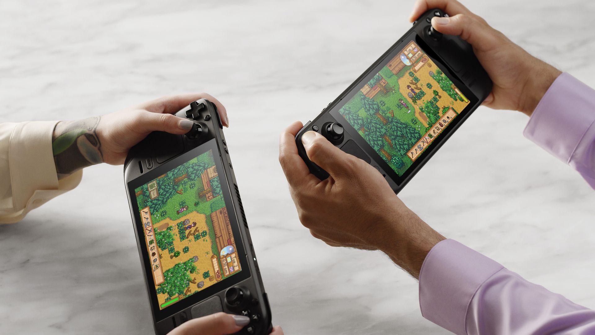 Photo of two sets of arms playing games on a handheld game consoler 