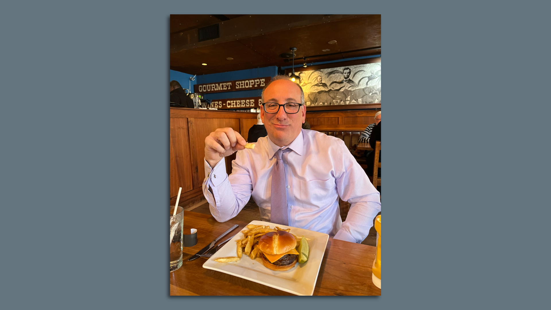 Michael Strazzella eating a burger and fries at the Hawk 'N' Dove.