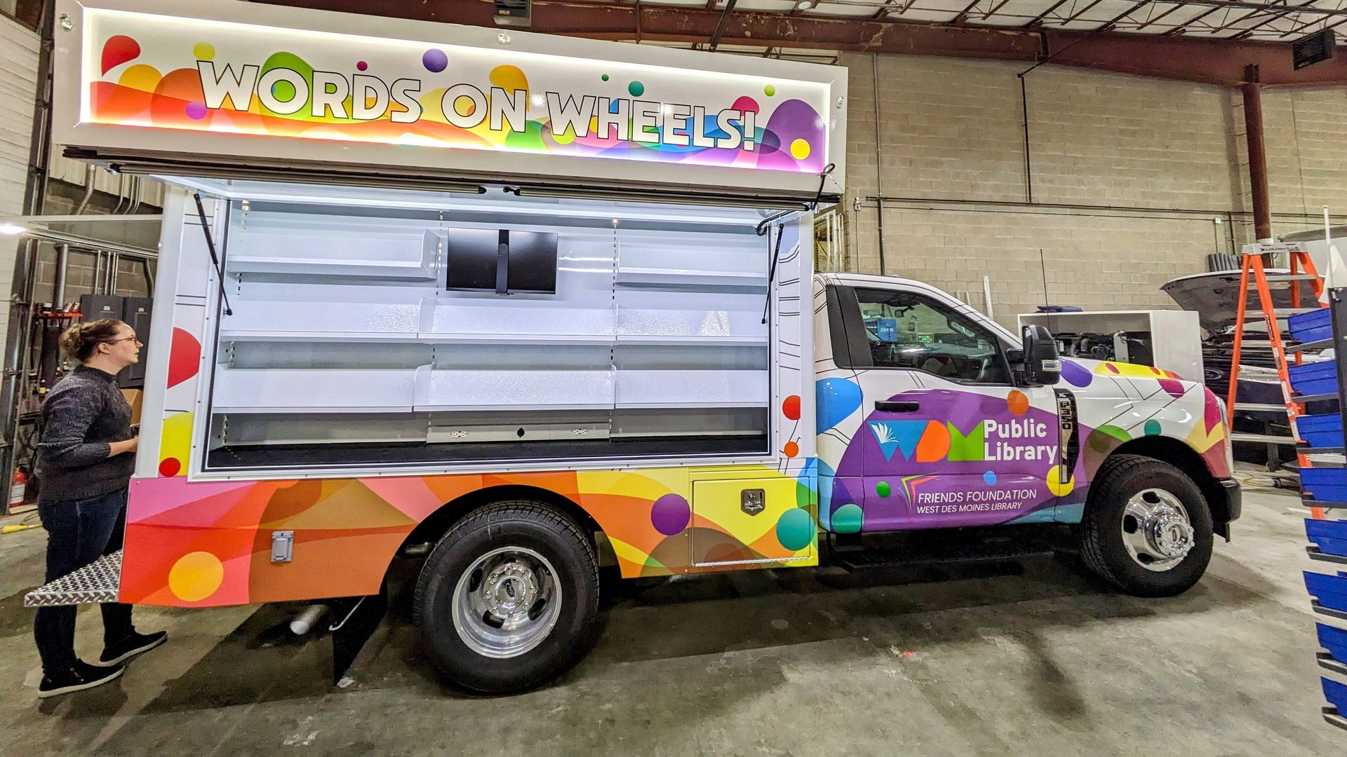 The Words on Wheels truck in a warehouse