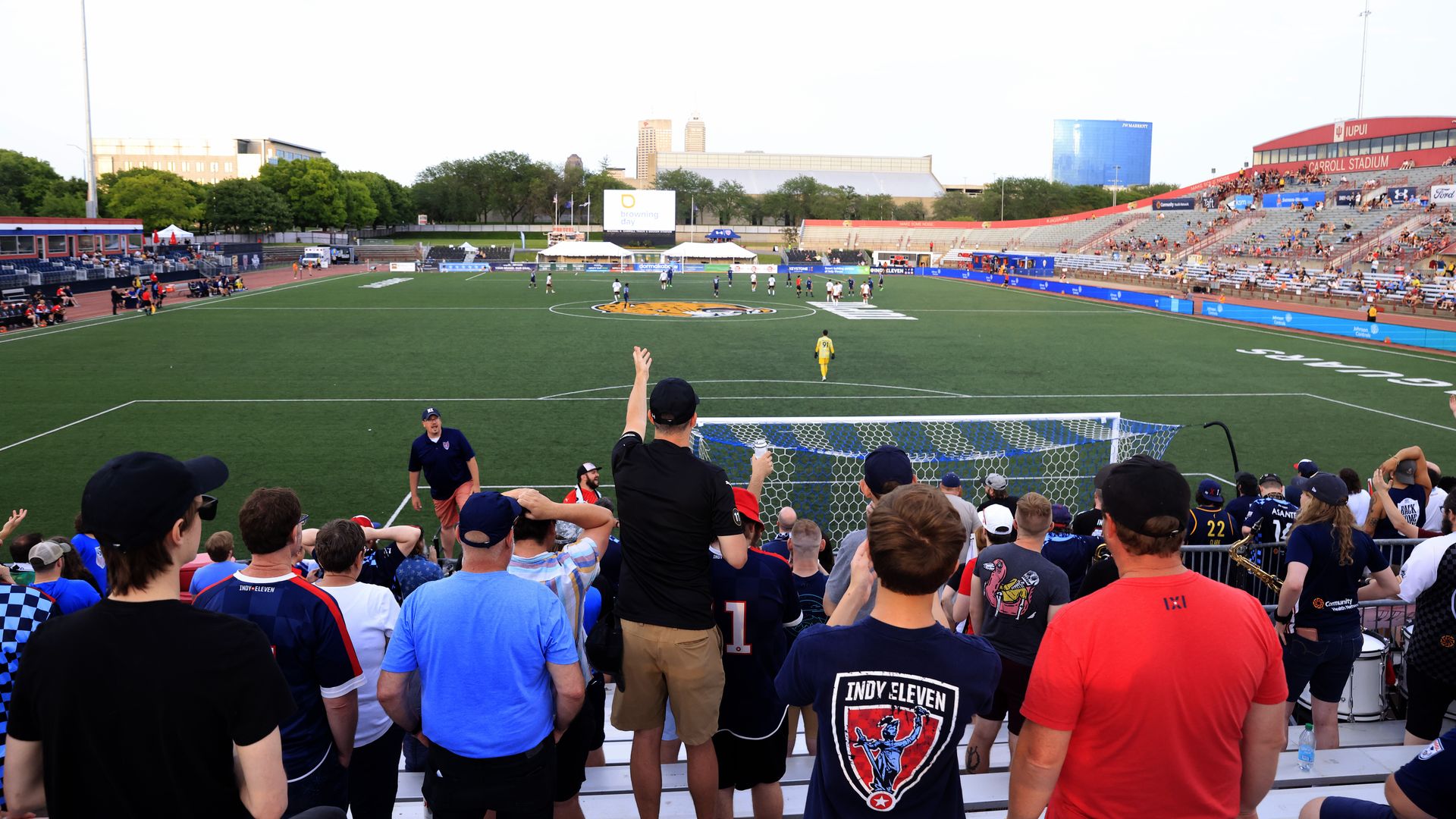 A soccer field with fans in the foreground