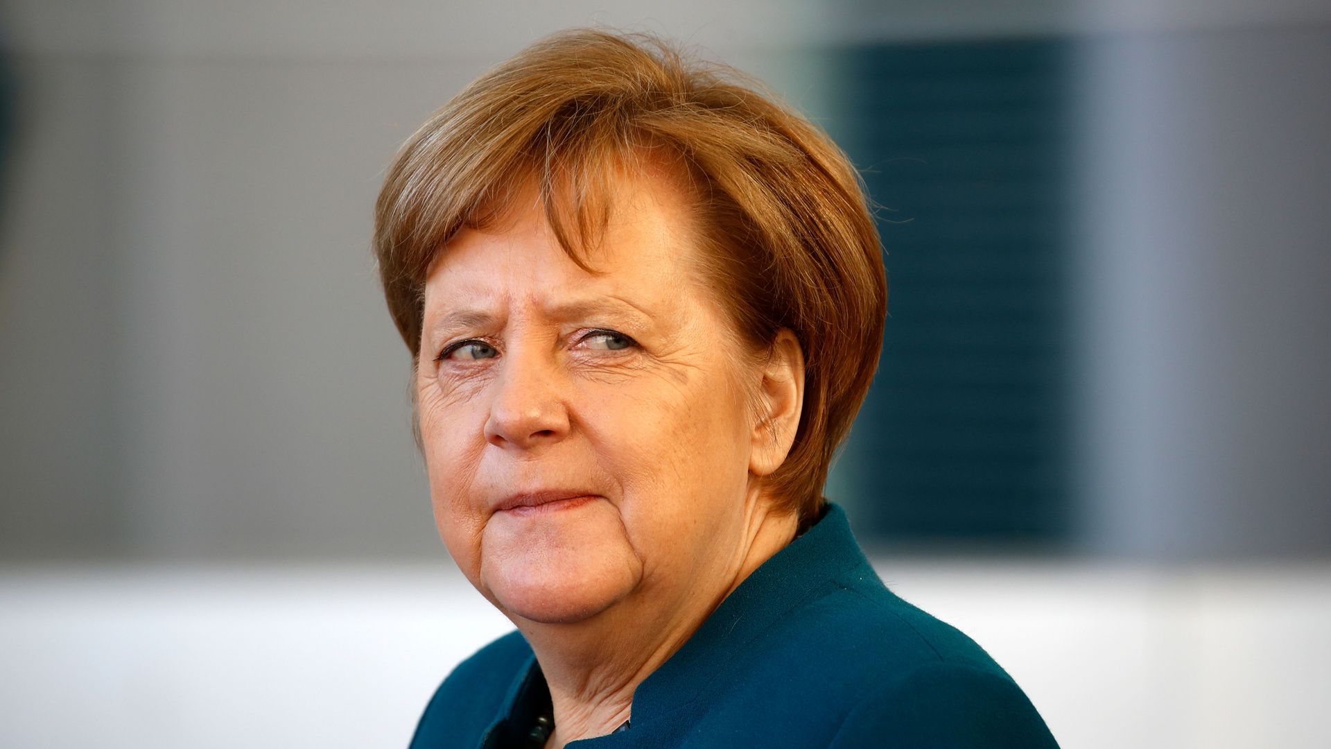 Angela Merkel looks skeptical.