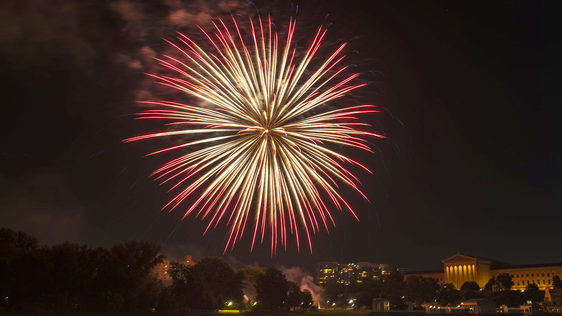A photo of large red fireworks erupting over the Philadelphia Art Museum on July 4, 2021.