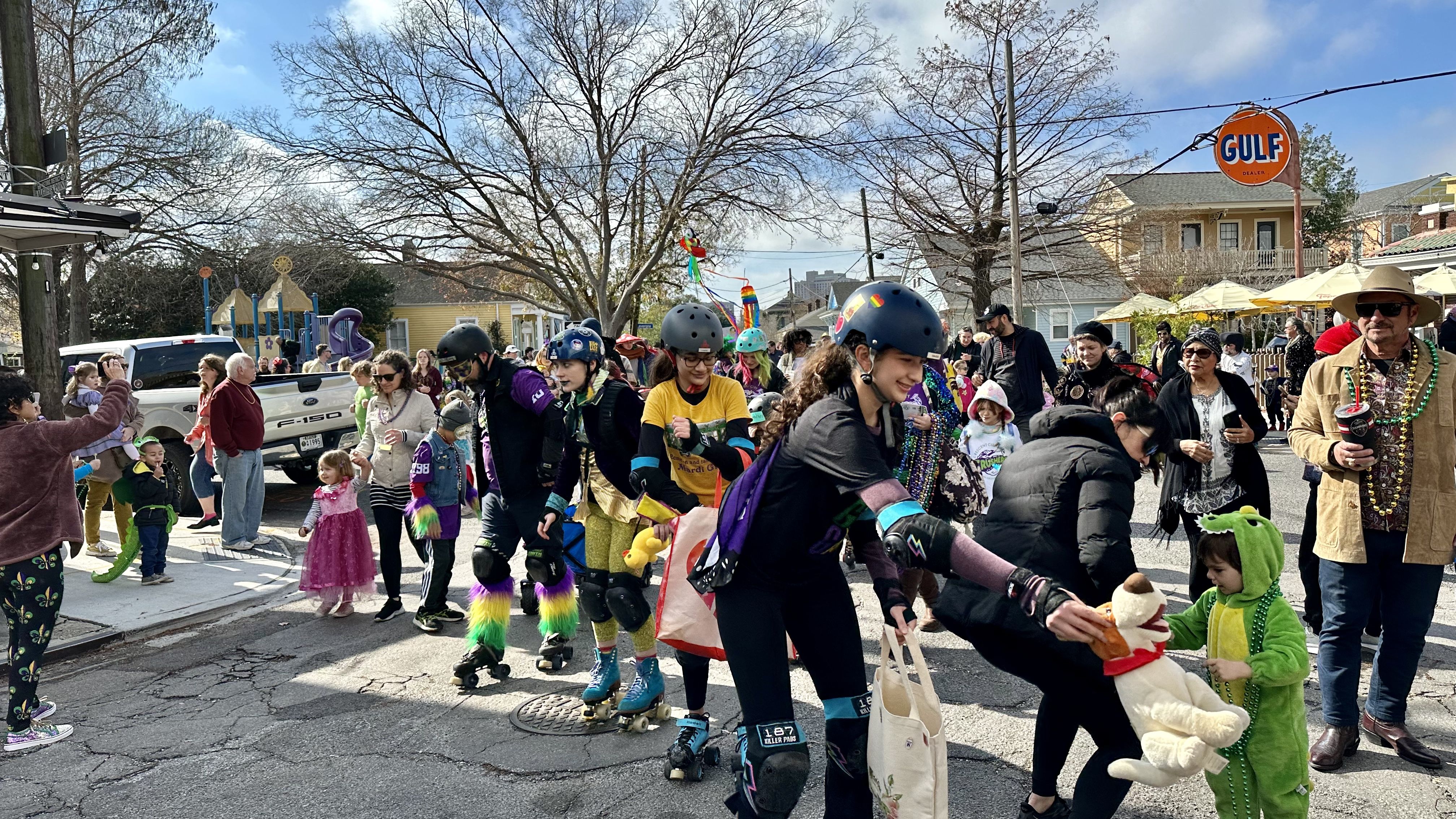 Photo shows children in costume walking in the Krewe of Confetti Kids parade in Algiers Point in New Orleans.