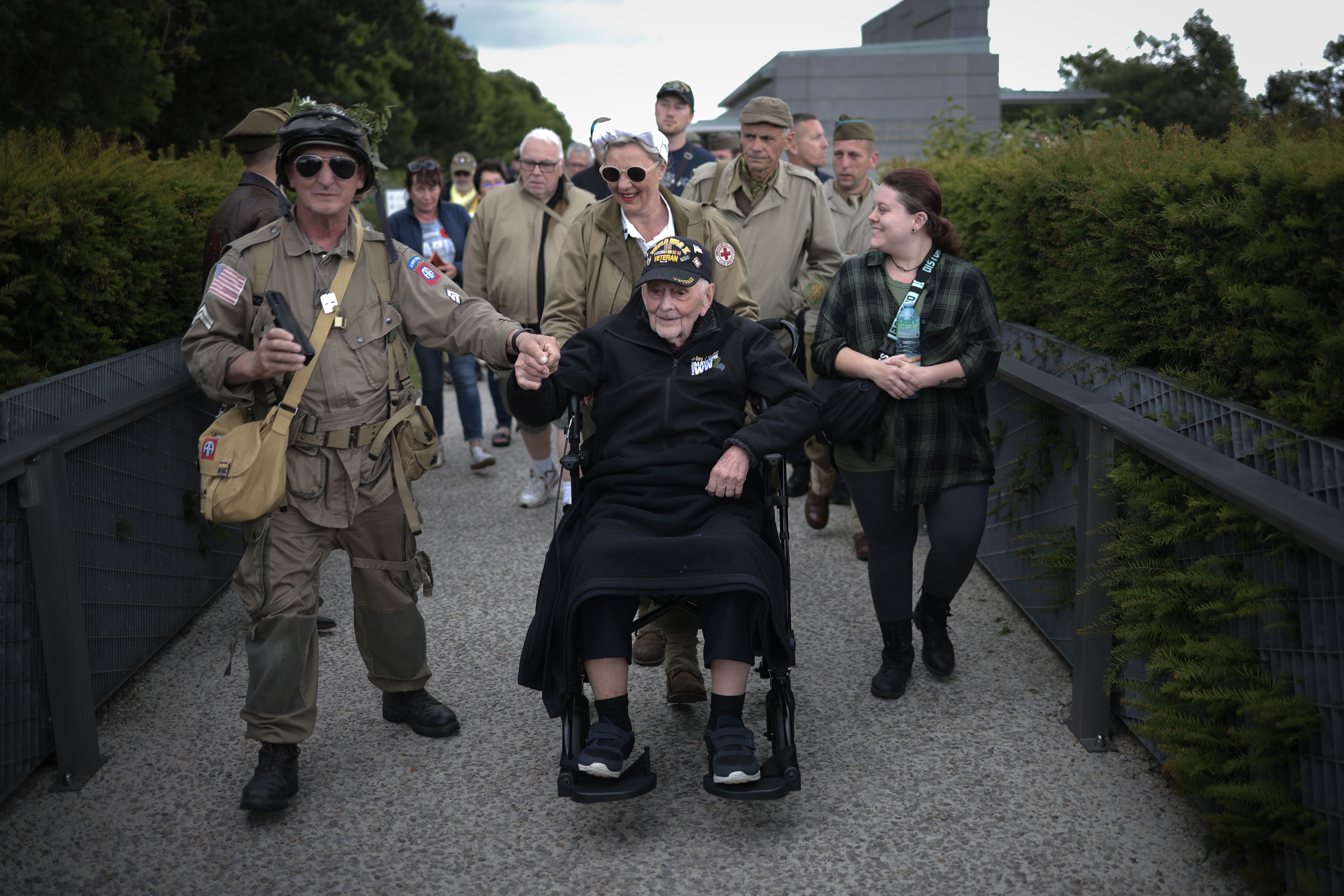102-year-old World War 2 veteran Gene Kleindl (left) from Rockford, Illinois, greeting visitors and re-enactors at the Normandy American Cemetery on June 04, 2024, in Colleville-sur-Mer, France.