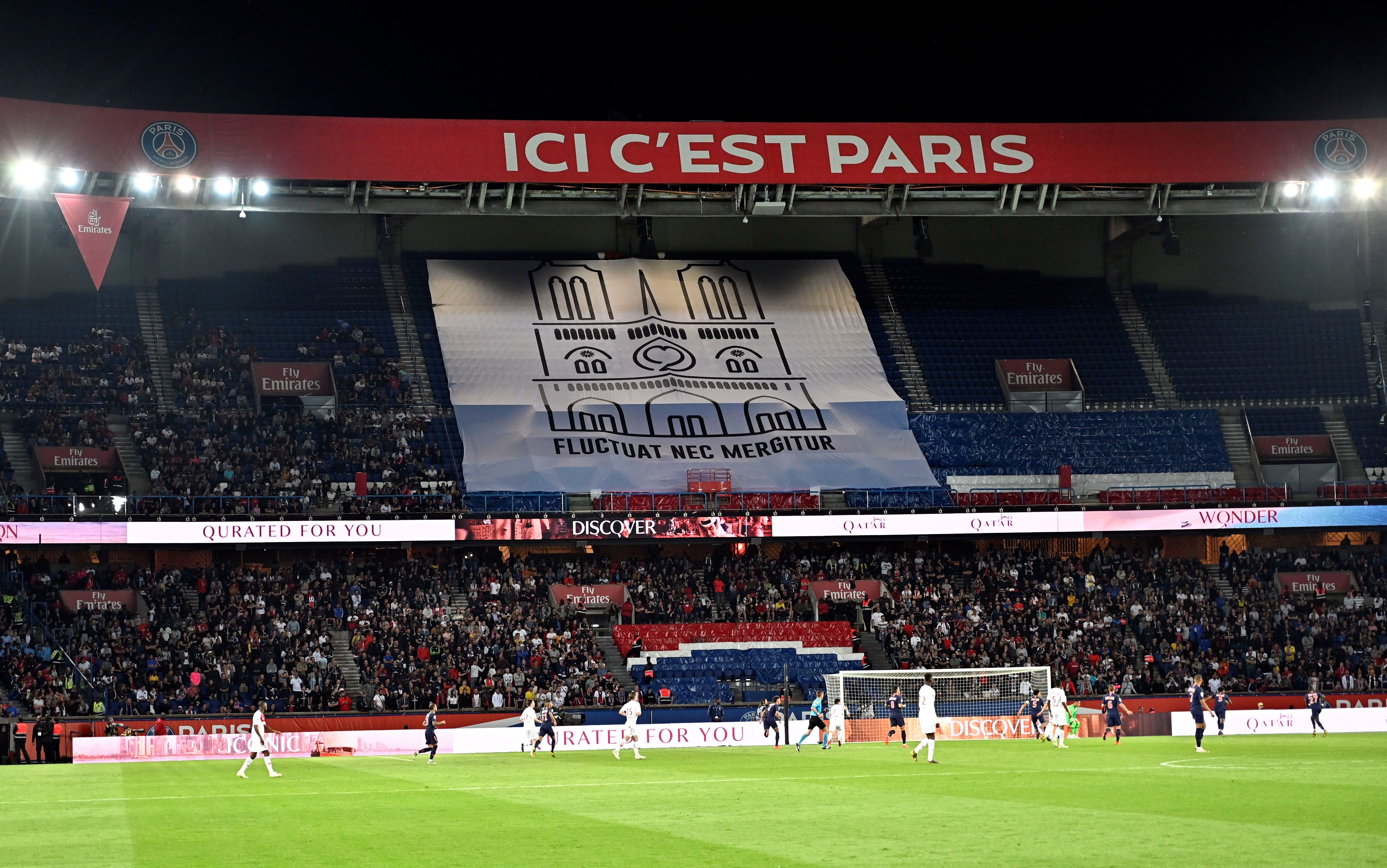 A banner showing a drawing of Notre Dame cathedral is displayed during PSG's game