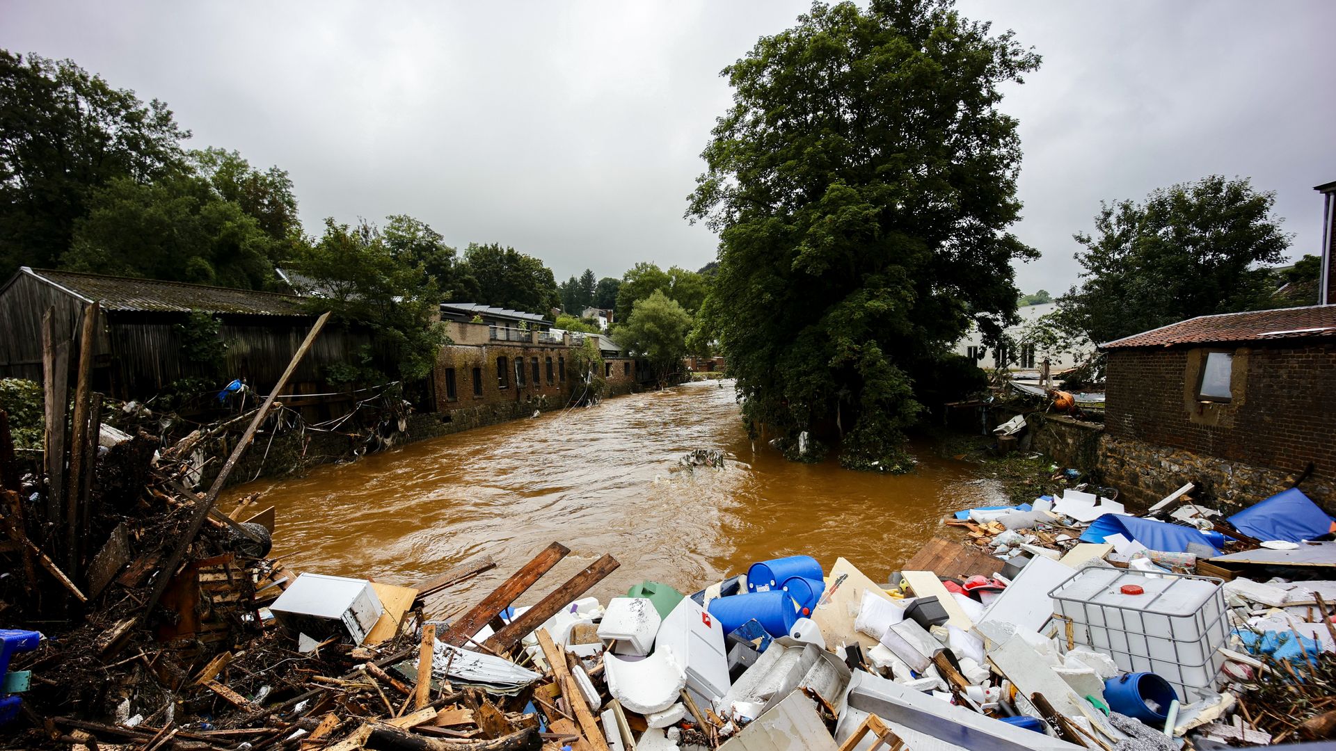Citizens clear up their flood damaged houses on July 16