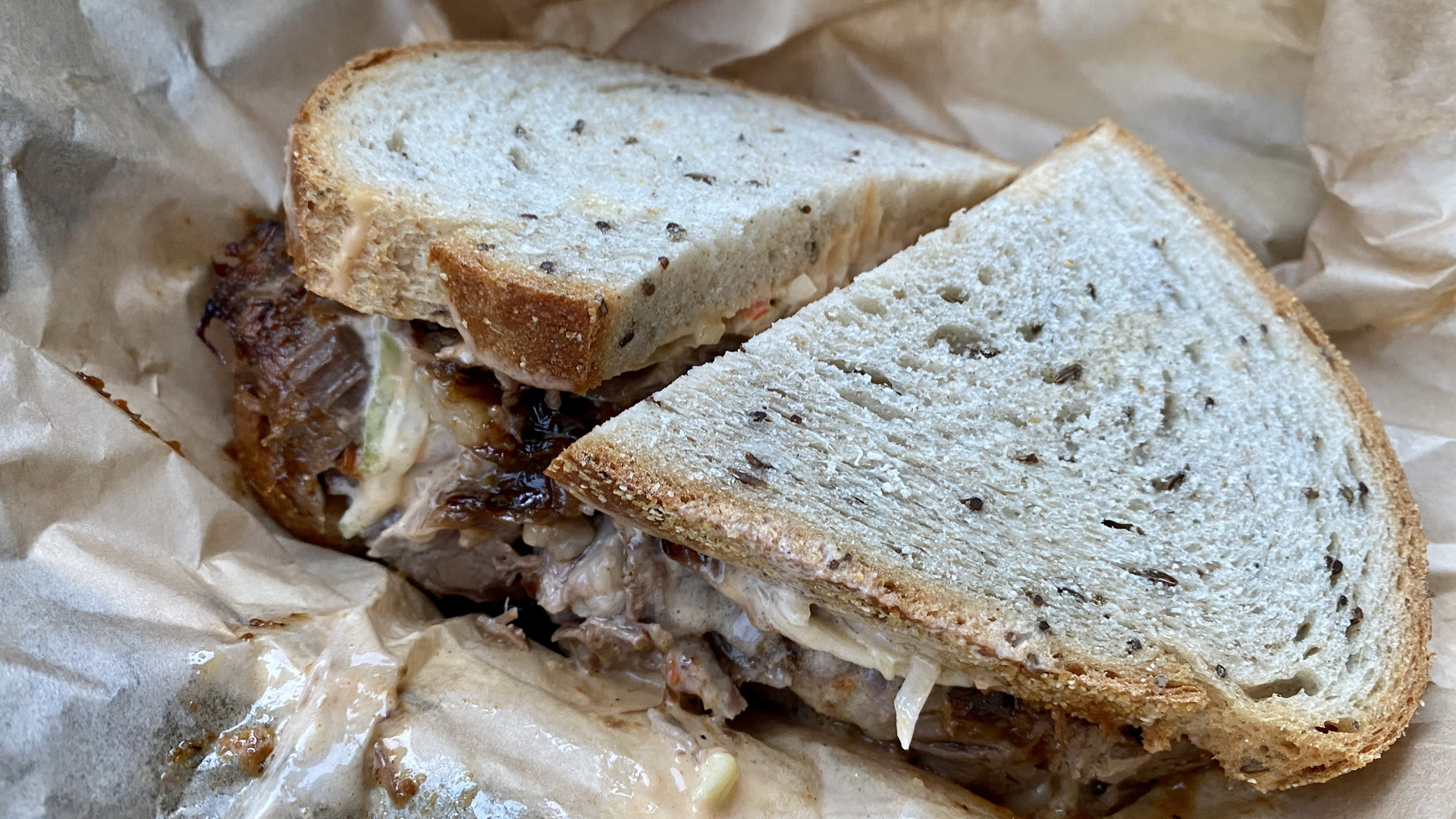 A sandwich on seeded rye, exploding with brisket.