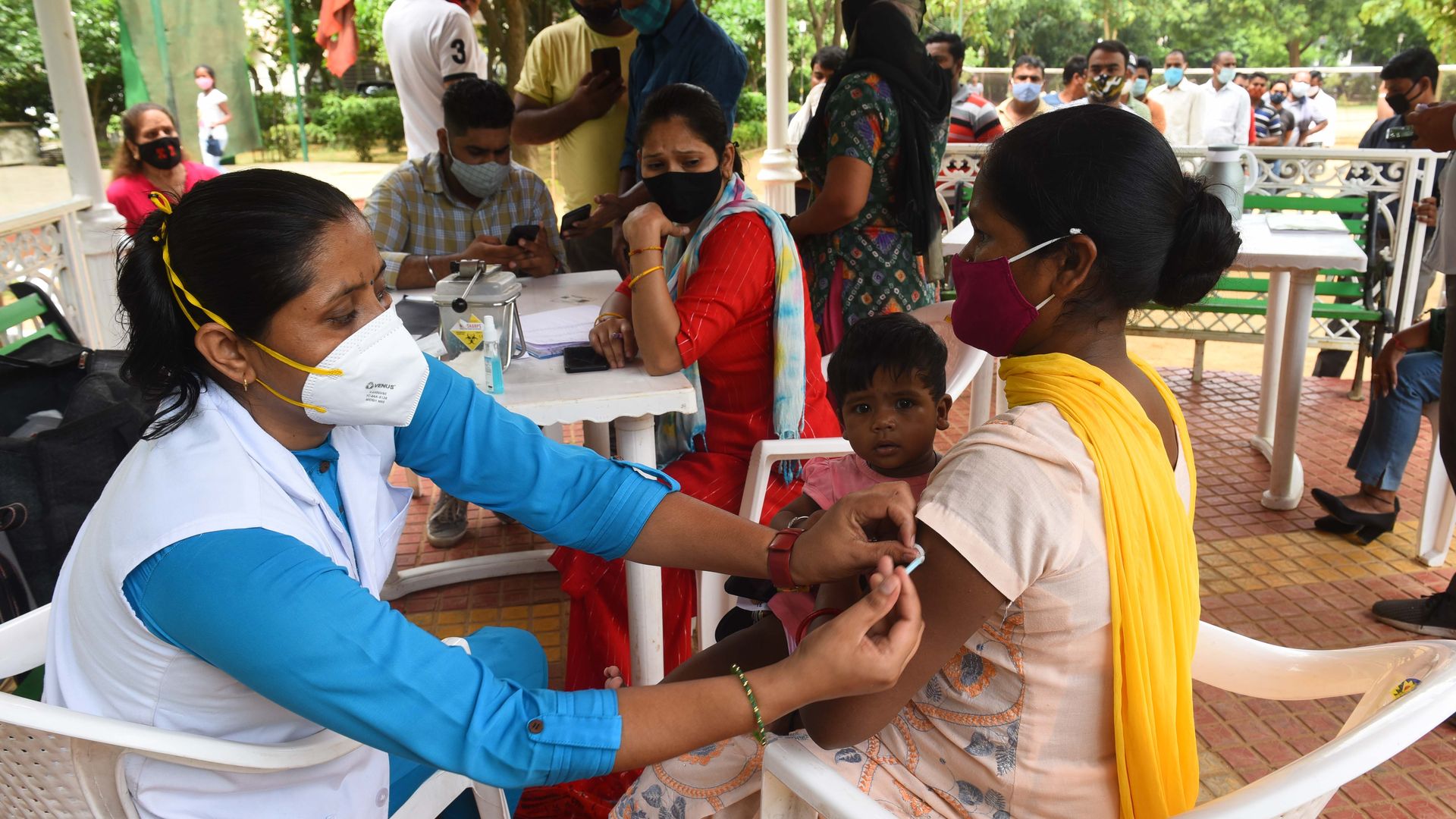 A woman in India get a COVID-19 vaccine dose