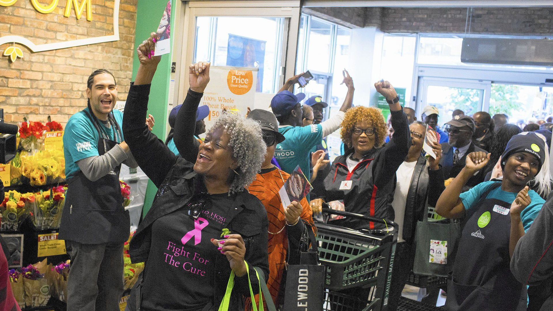 People cheering at t grocery store