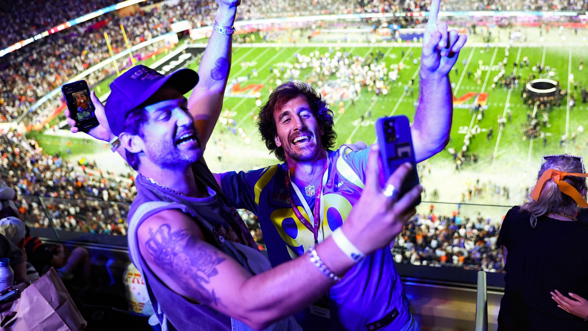 Two Rams fans celebrate in the stands after their team's Super Bowl vistory.