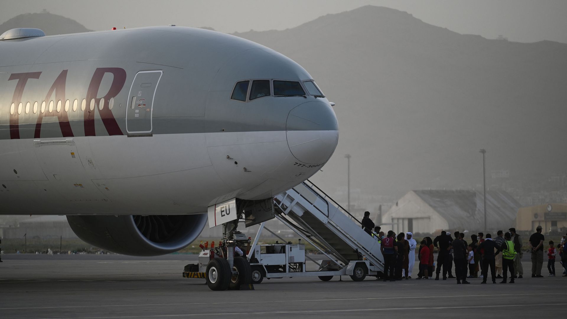 Passengers board a Qatar Airways aircraft bound to Qatar at the airport in Kabul on September 10, 2021. 