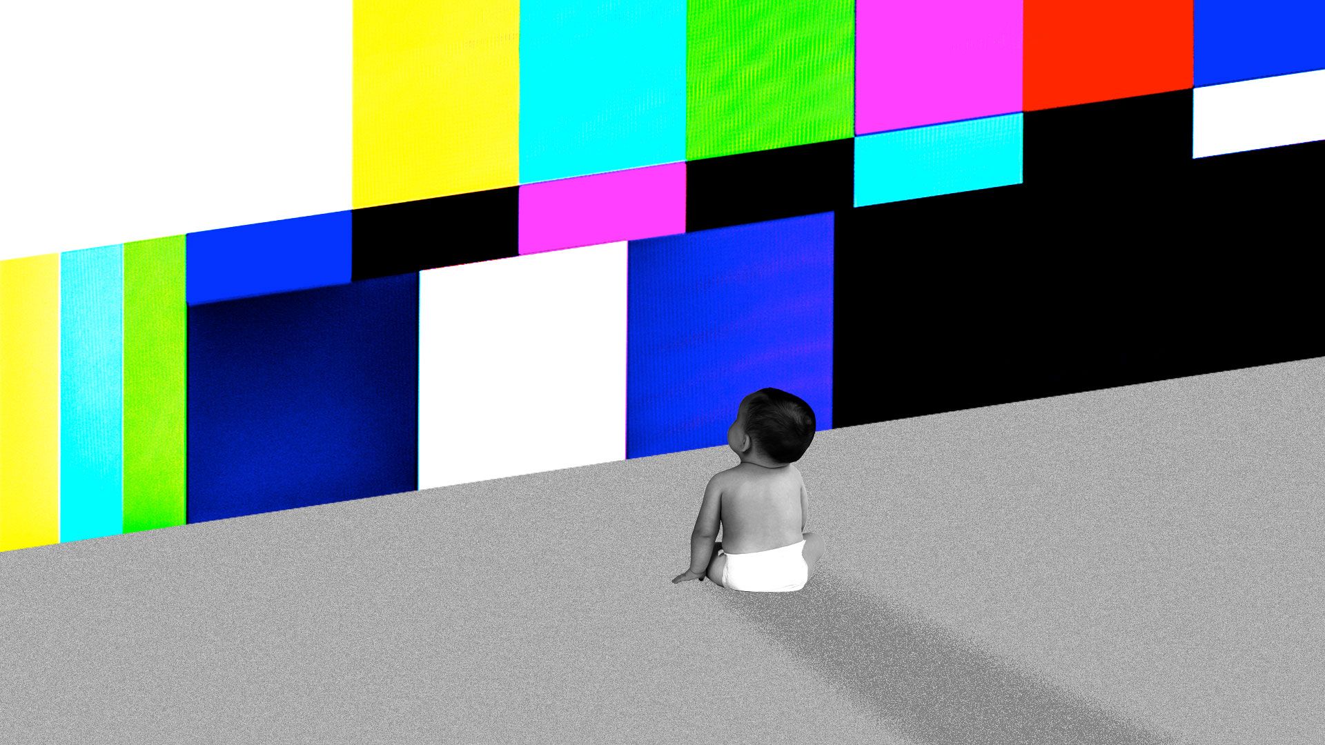 In this image, a baby faces a large multi-colored screen. 