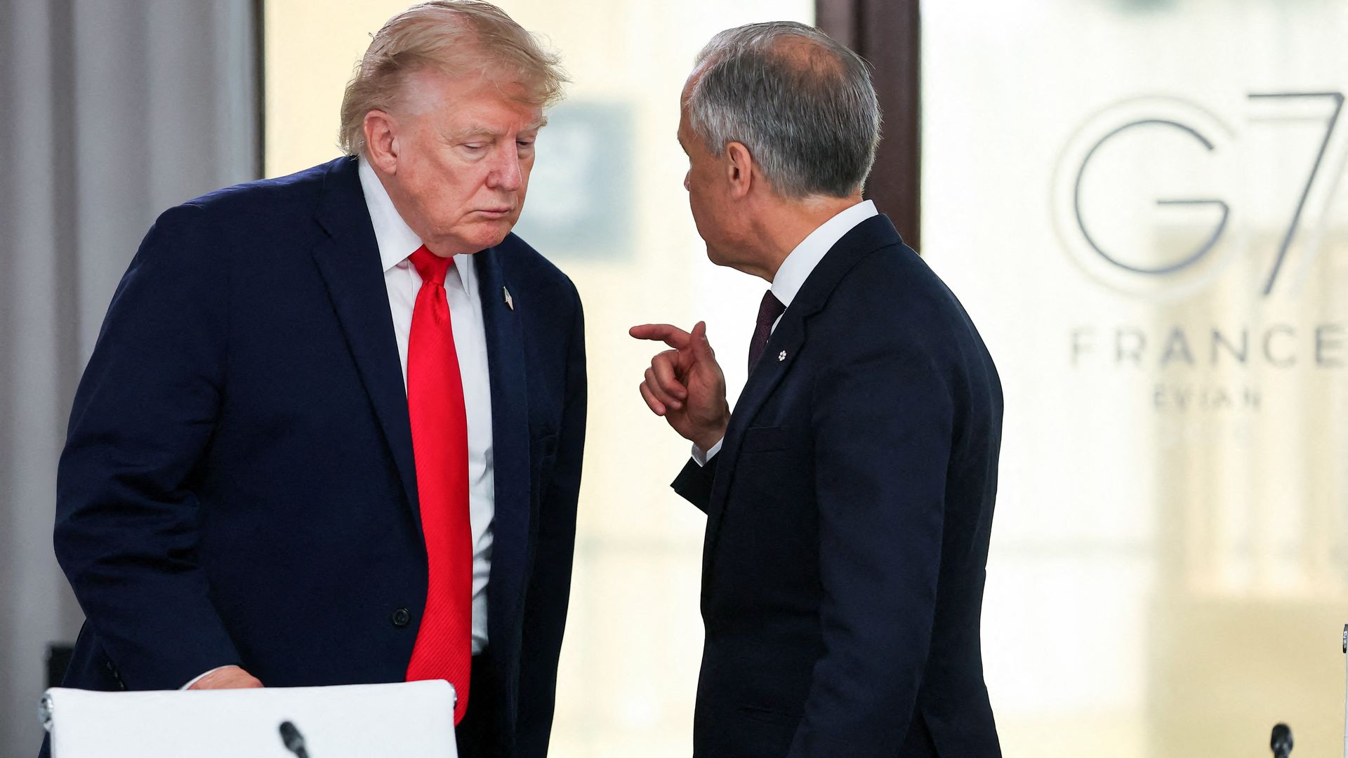 US President Donald Trump (L) speaks with Canada's Prime Minister Mark Carney during a work lunch as part of the G7 summit, in Evian, eastern France, on June 16, 2026. 