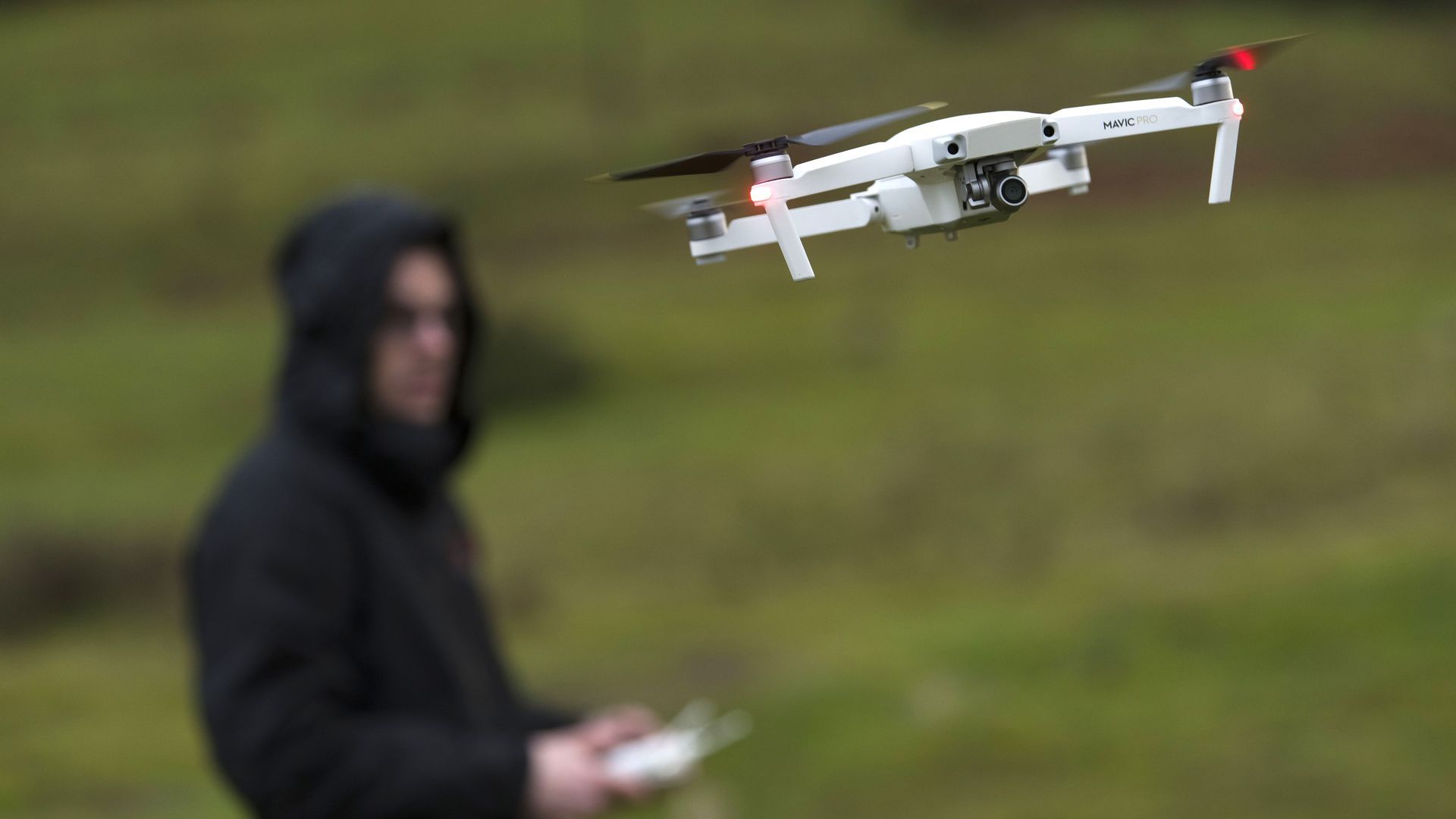 A man flies a consumer drone.