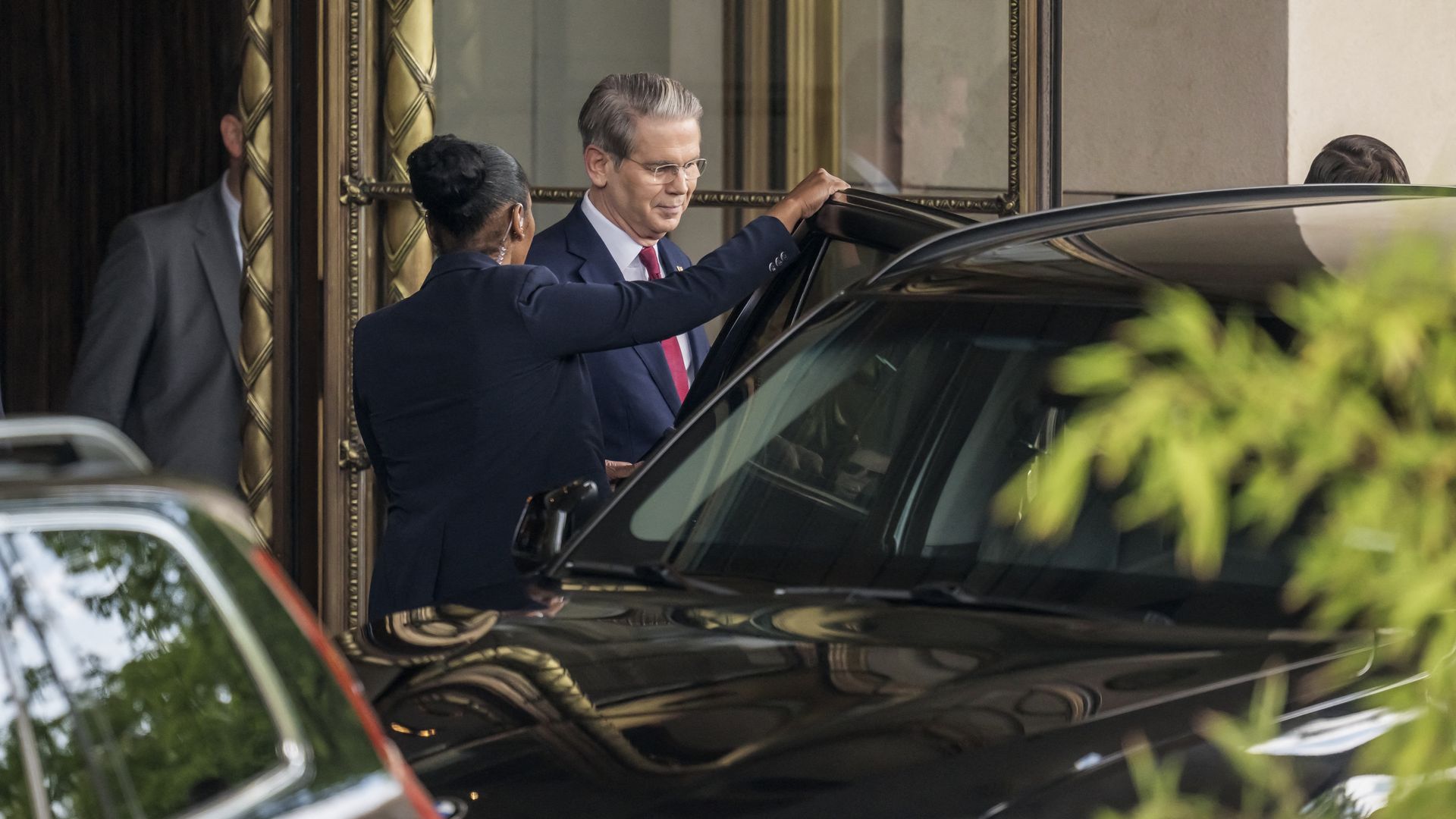 Treasury Secretary Scott Bessent entering a car outside a Swiss hotel.