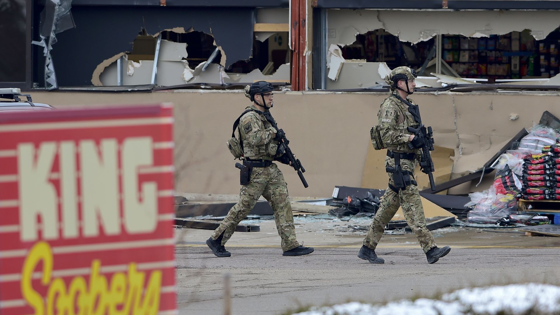 Armed police officers are seen outside a King Soopers on Table Mesa Drive in Boulder after reports of shots fired on March 22, 2021.