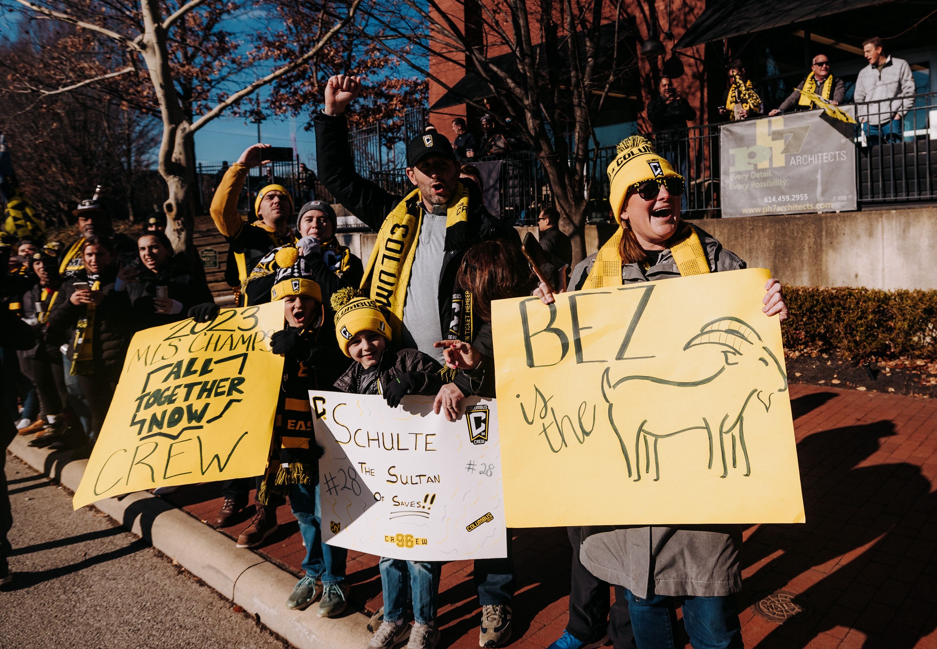 Crew fans line Nationwide Boulevard with signs during the parade, including one that says "Bez is the goat"