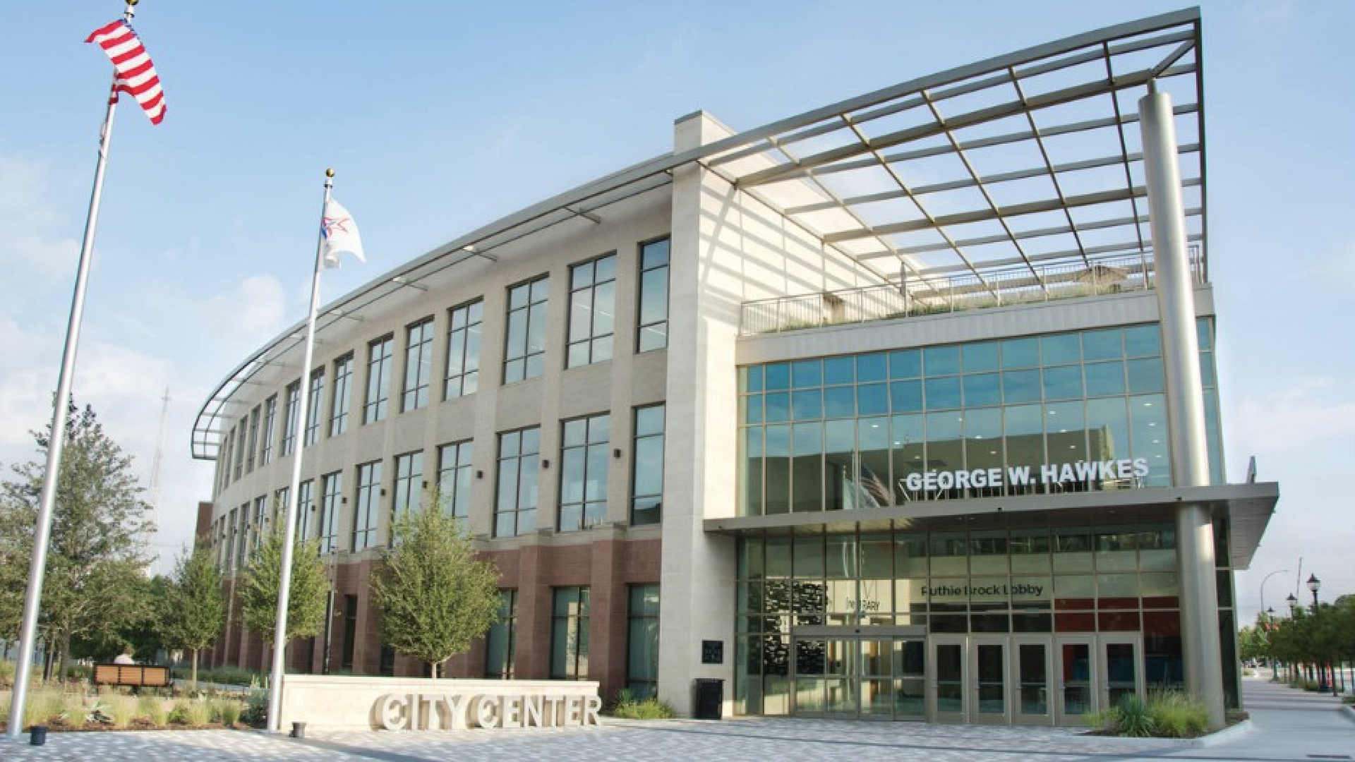 A glass and cement building with a sign out front that says City Center