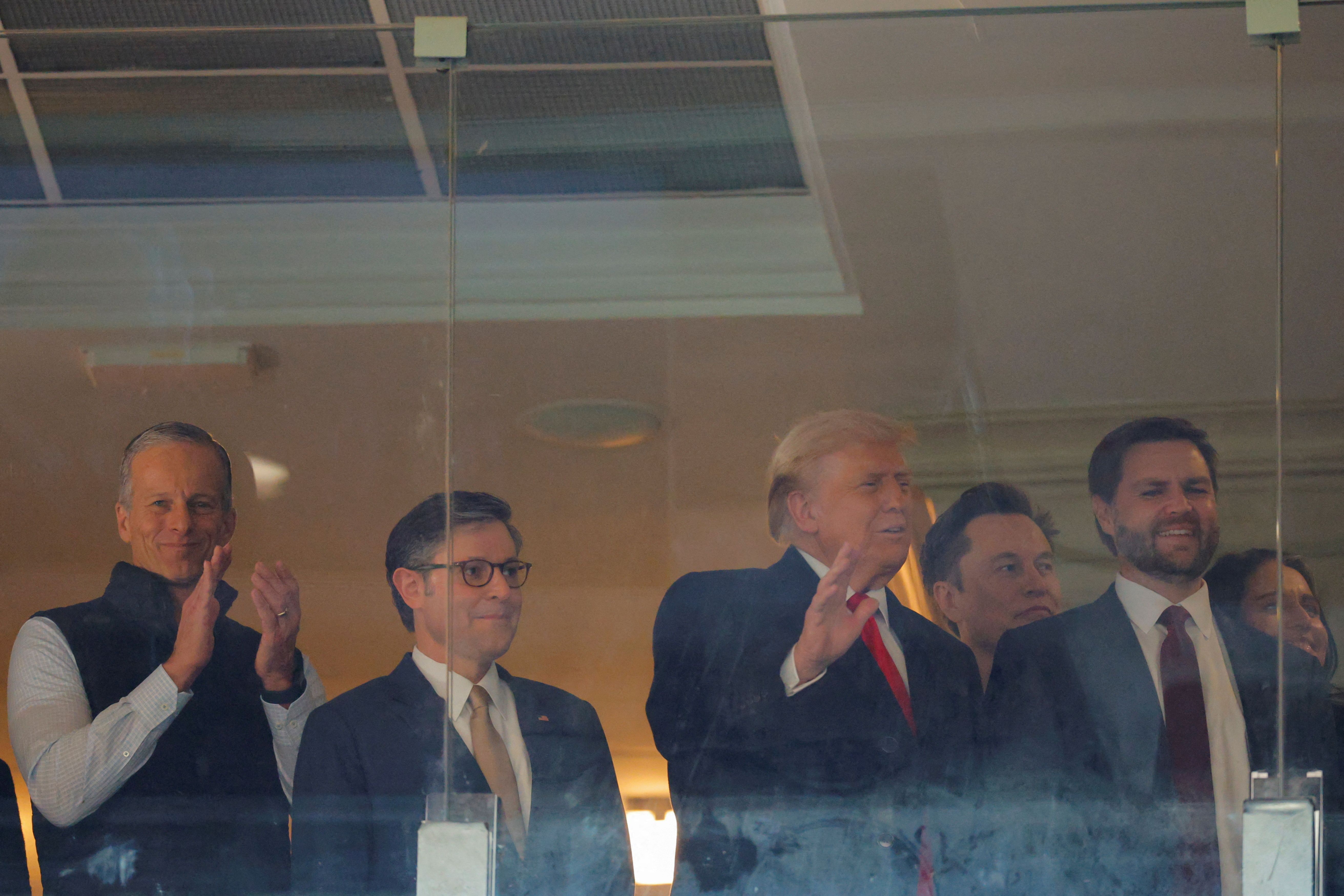 U.S. Senator John Thune (R-SD), House Speaker Mike Johnson (R-LA), President-elect Donald Trump, businessman and proposed DOGE commission co-chair Elon Musk, Vice President-elect J.D. Vance and director of national intelligence nominee Tulsi Gabbard, attend the Army-Navy football game in Landover, M