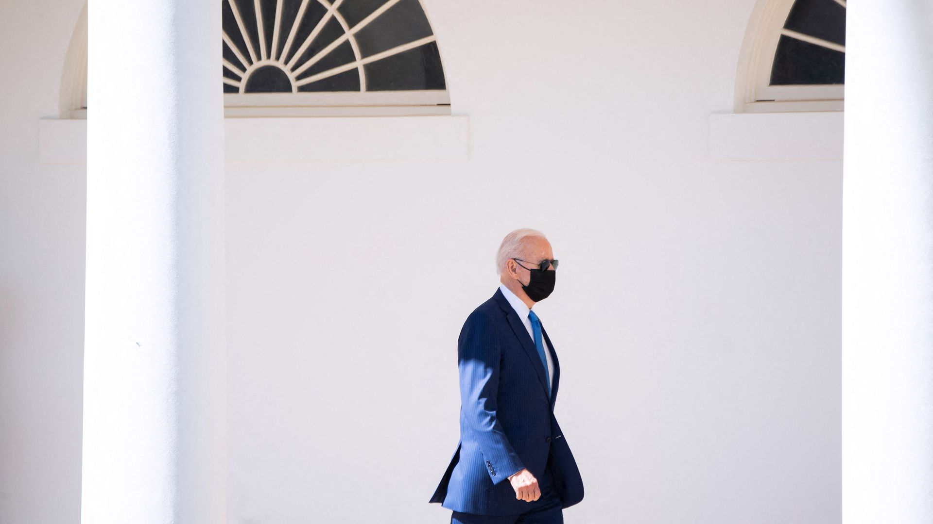 President Joe Biden walks alongside the West Wing Colonnade