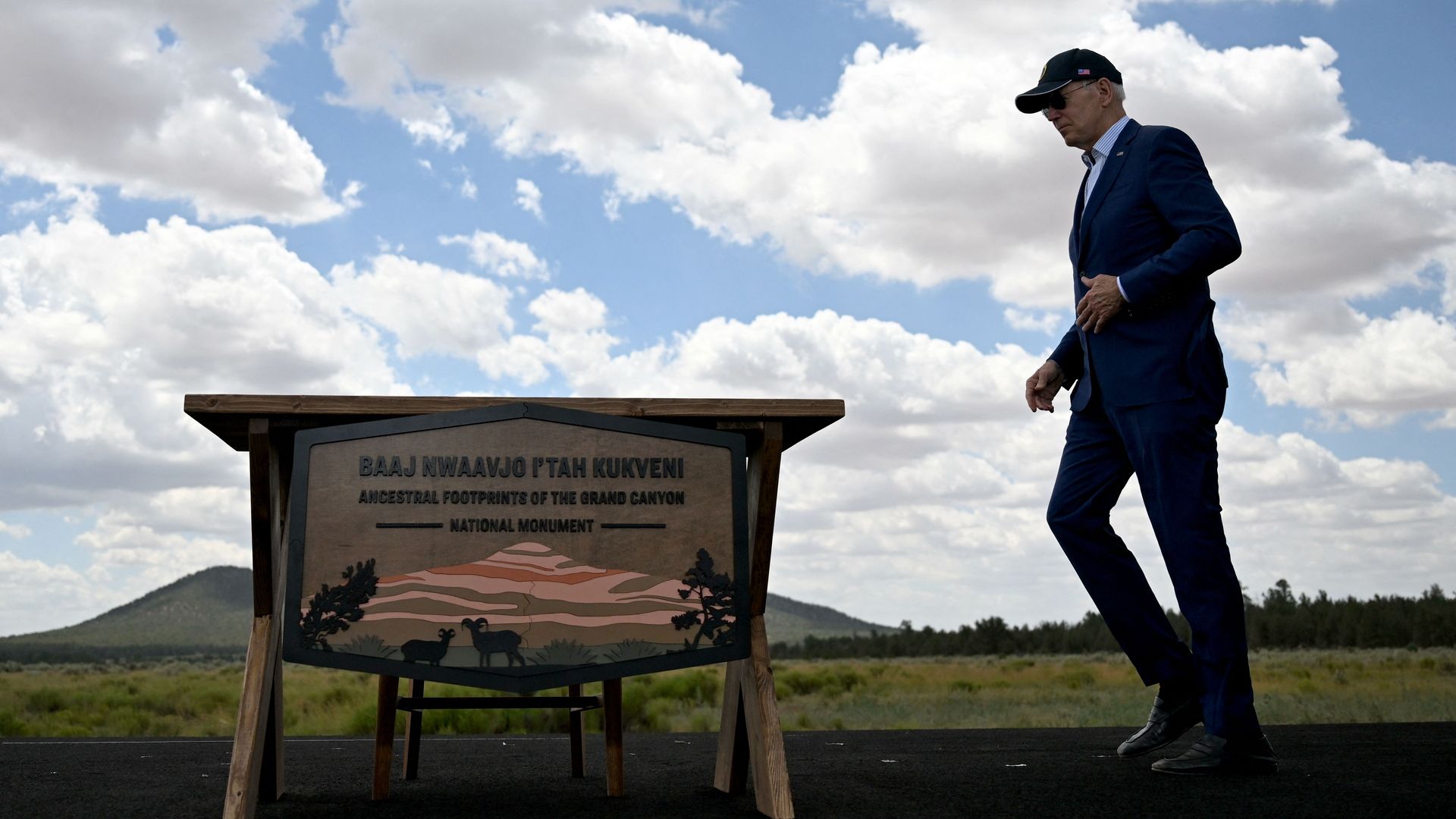 Presiden Biden walking pas a sign for the Grand Canyon Ancestral Footprints Monument.