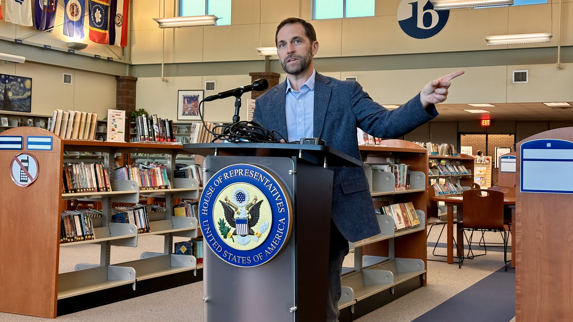 U.S. Rep. Jason Crow (D-Aurora) takes questions from reporters in the library at Hinkley High School in Aurora. Photo: John Frank/Axios